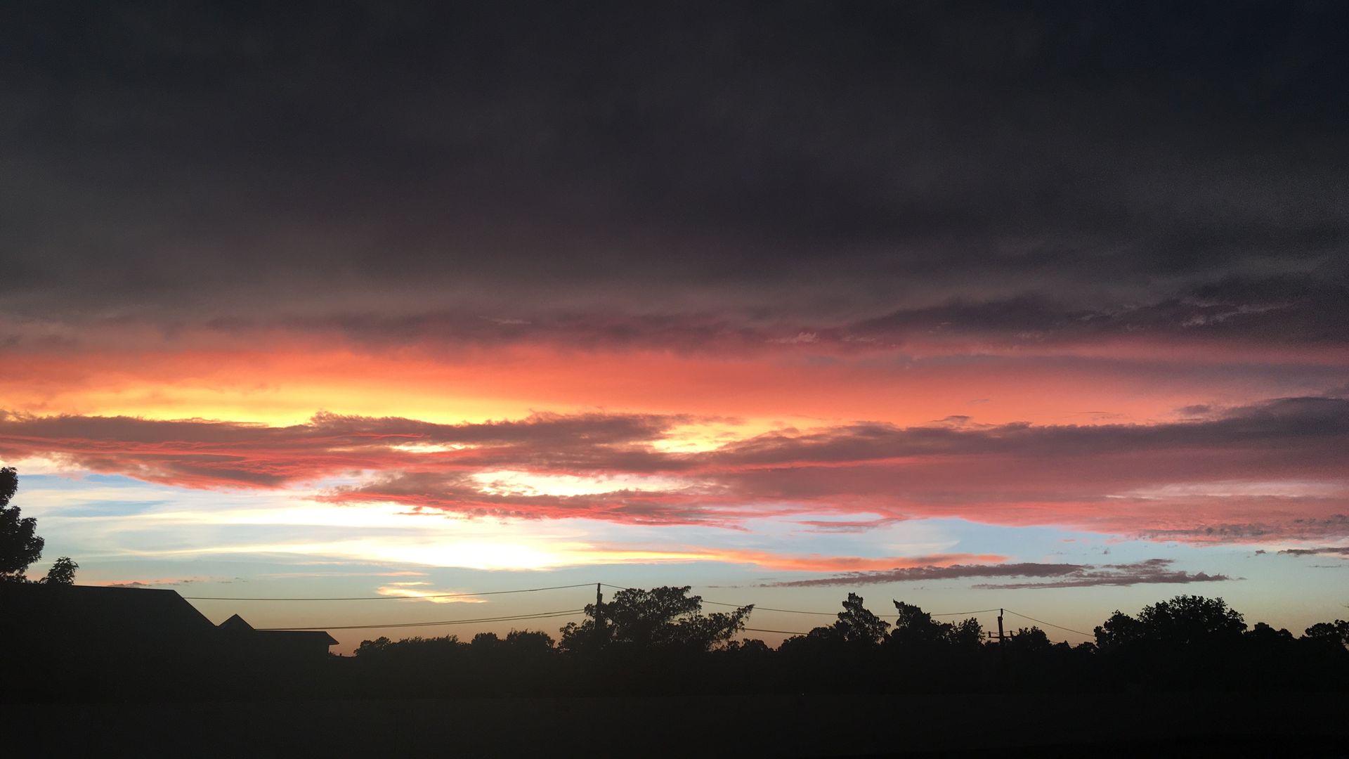 A vibrant red, orange, yellow and blue sunset created by Saharan dust over Houston
