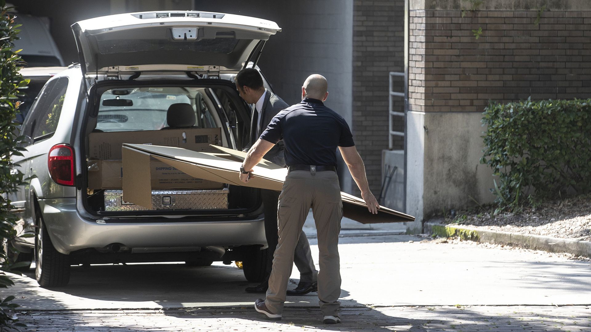 FBI agents loading artwork into a car