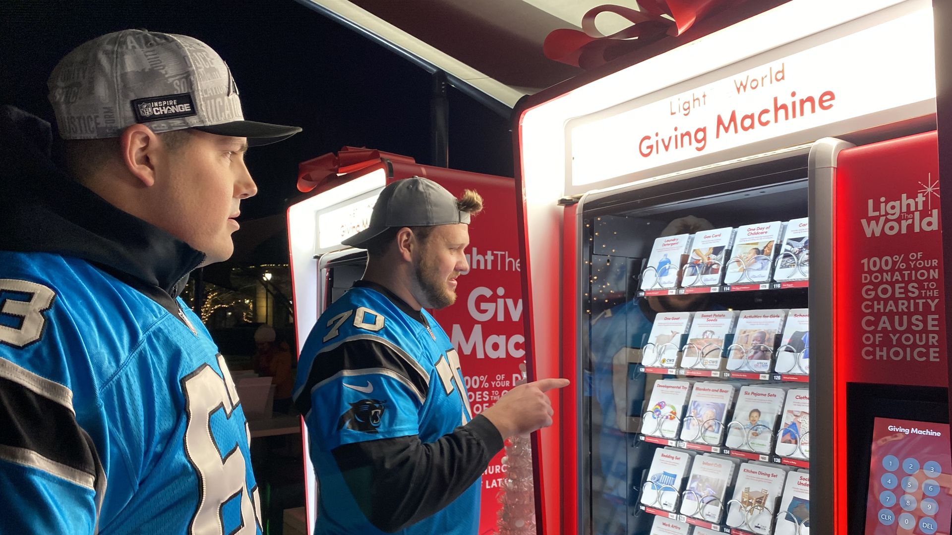 man pointing at a large vending machine