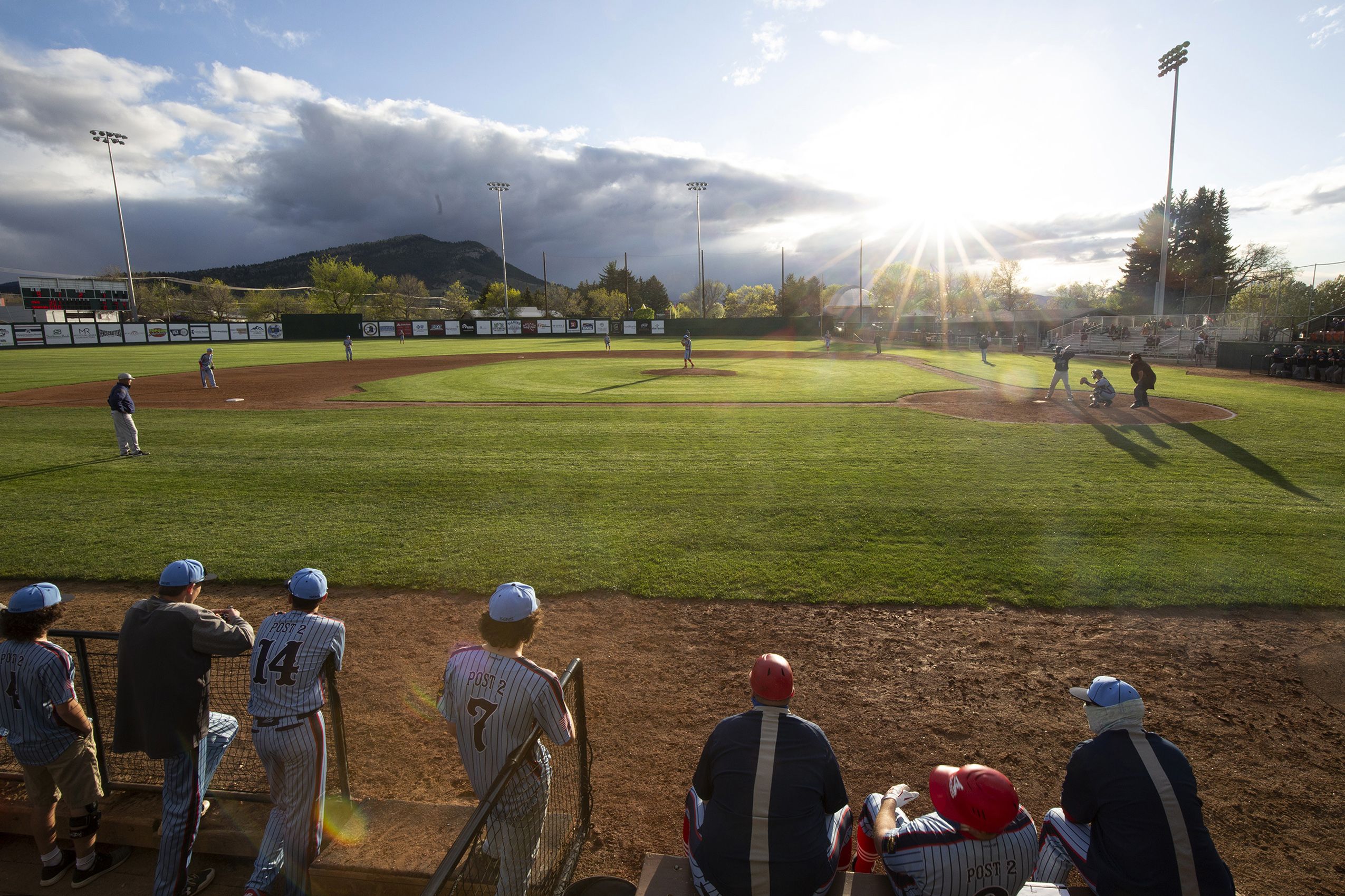 Baseball players look out at field