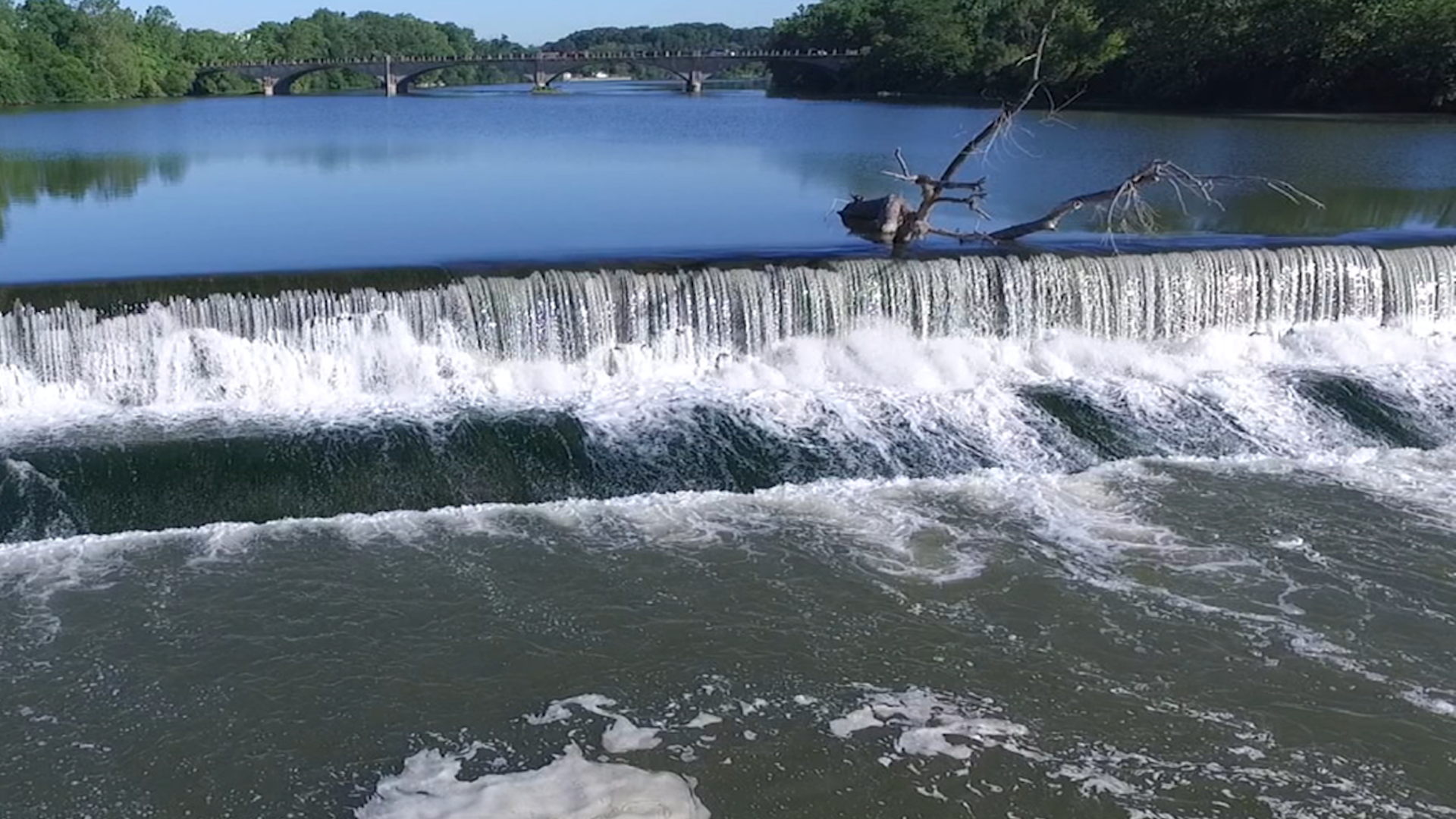 A low head dam creats a churning current on a river.