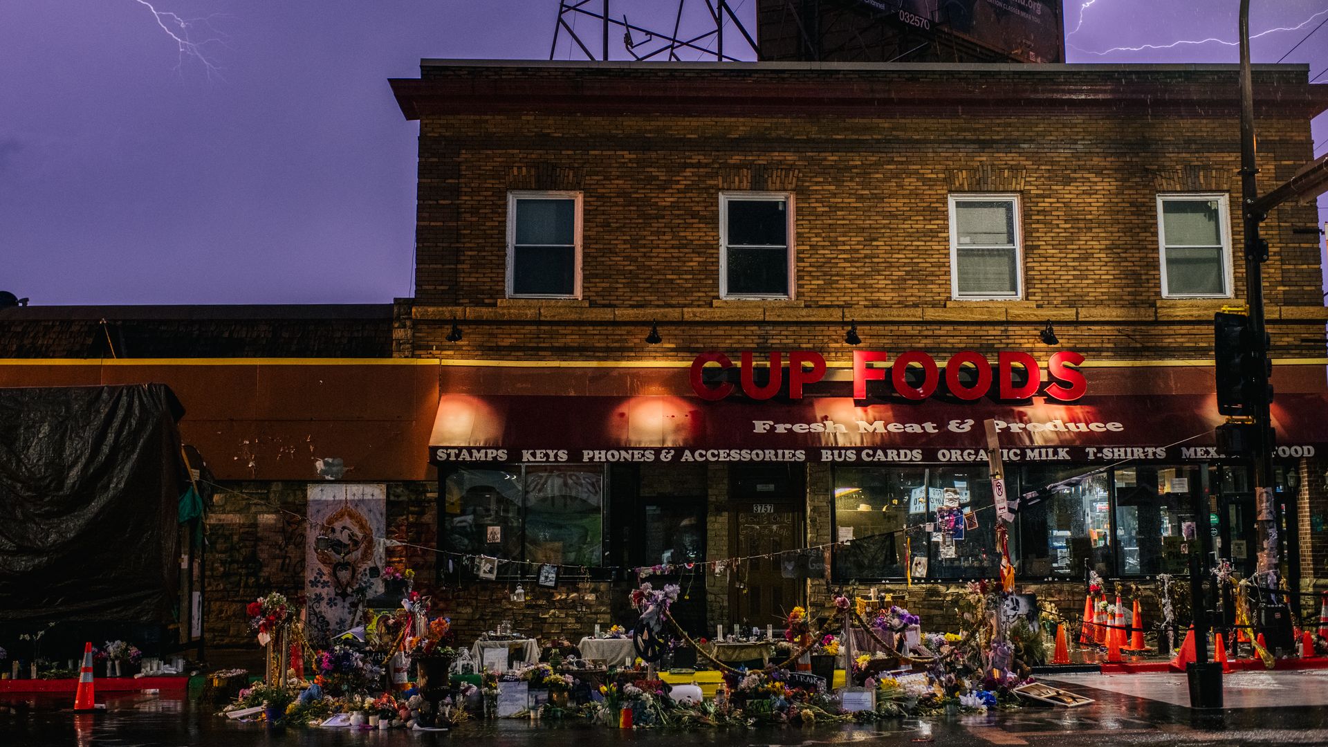 The entrance of Cup Foods, the site where George Floyd died, where people have laid flowers and signs.