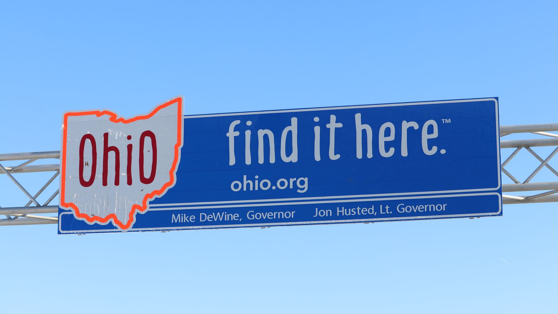 A highway sign that reads "find it here" next to an outline of Ohio's shape