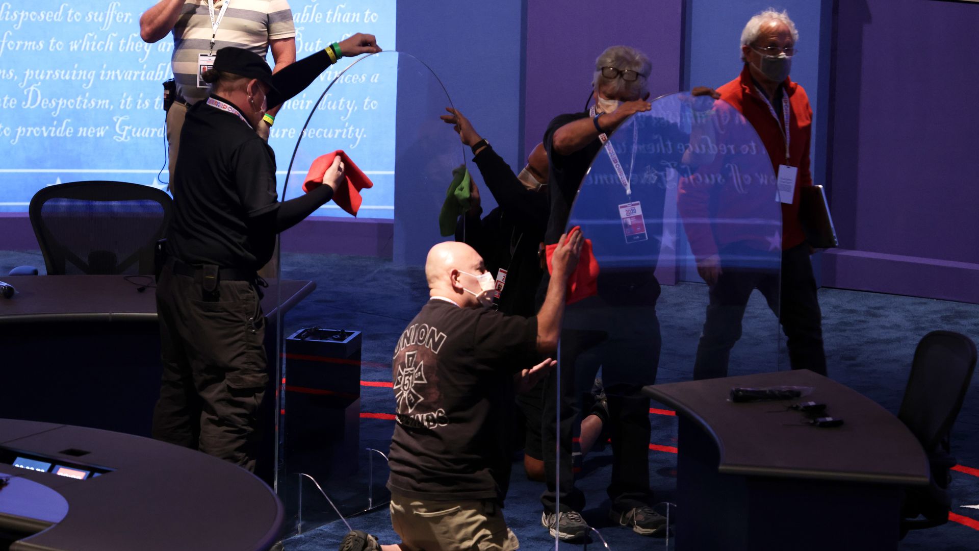 Workers install plexiglass