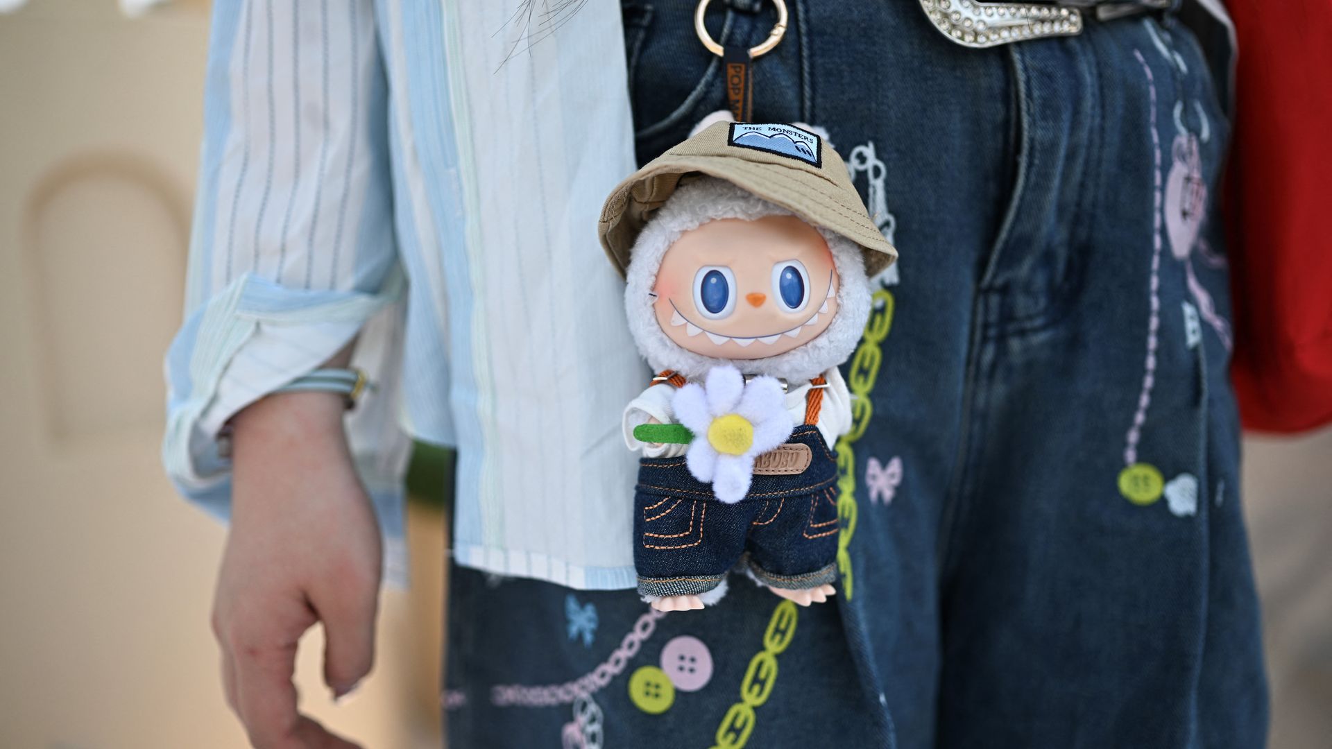 A person with a Labubu monster doll. 