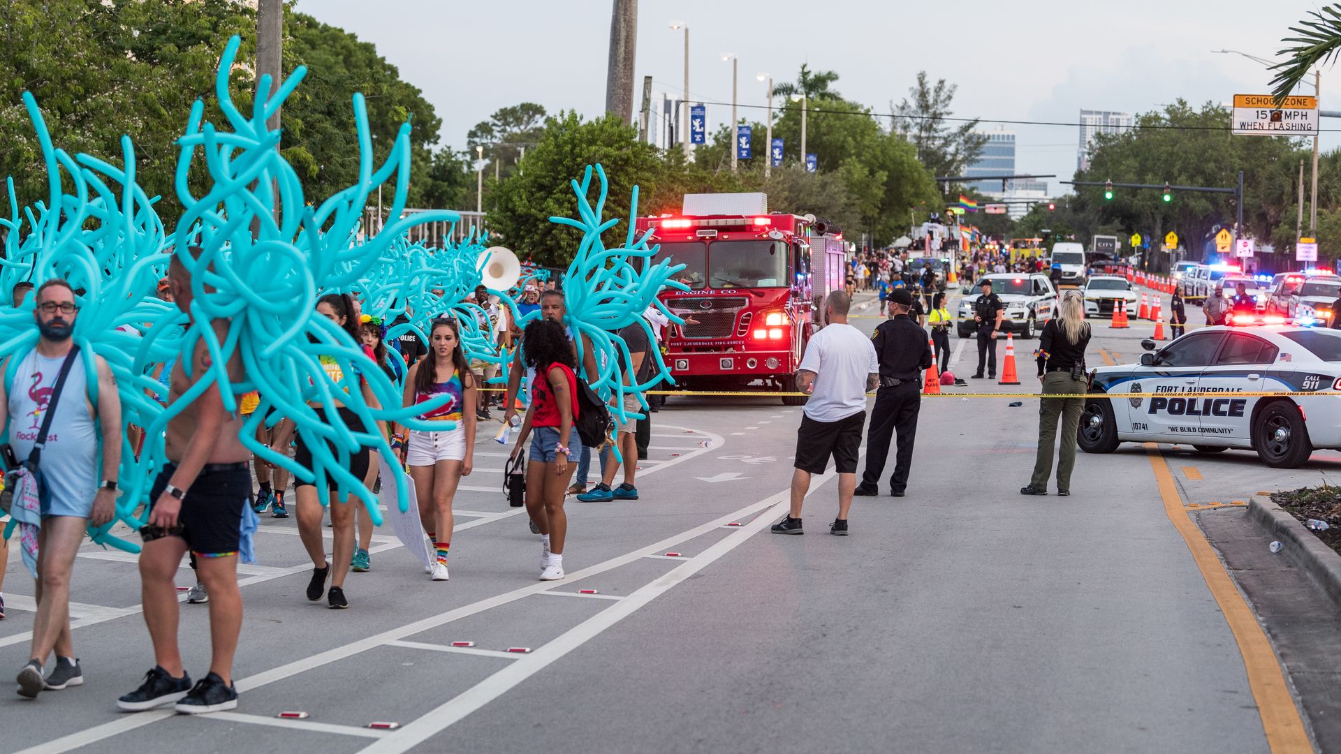  Parade participants walk away as police investigate the scene where a pickup truck drove into a crowd of people at a Pride parade on June 19, 2021 in Wilton Manors, Florida. 