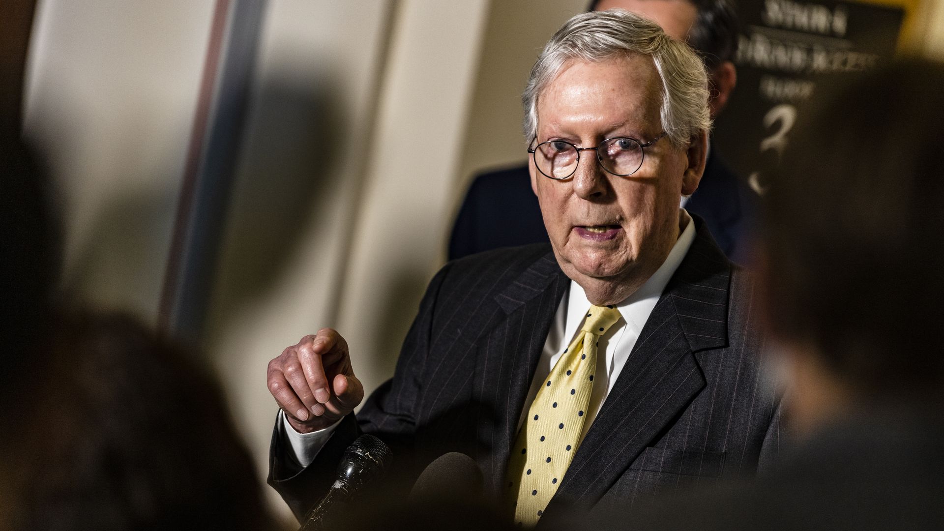 McConnell points a finger while wearing a suit and tie