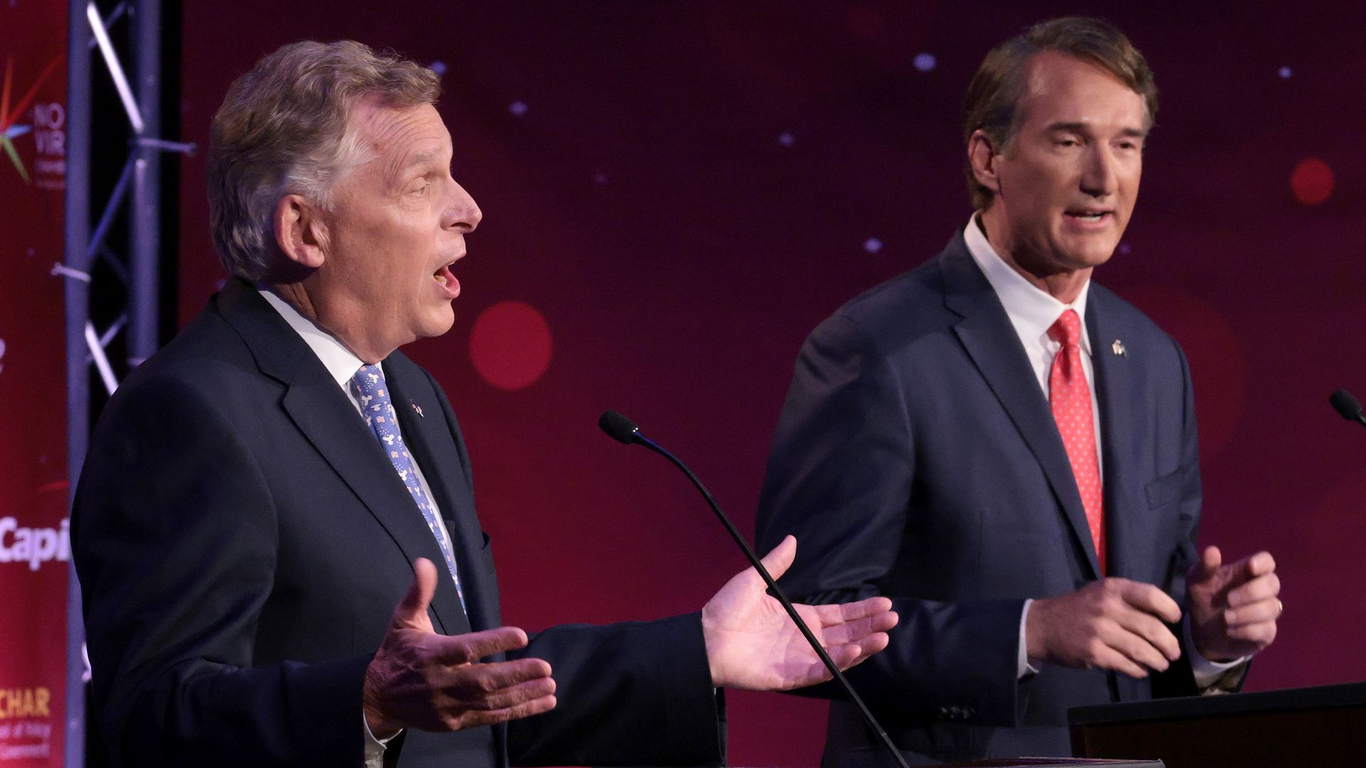 Terry McAuliffe and Glenn Youngkin are seen during a debate.