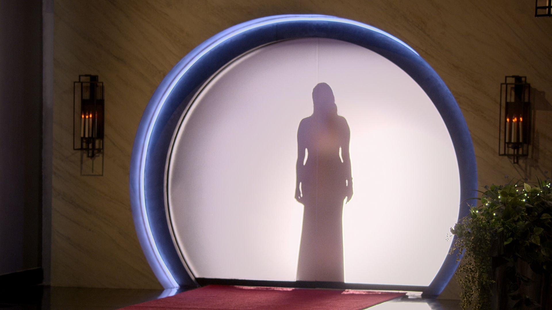 A photo showing a woman's silhouette outlined against a screen.