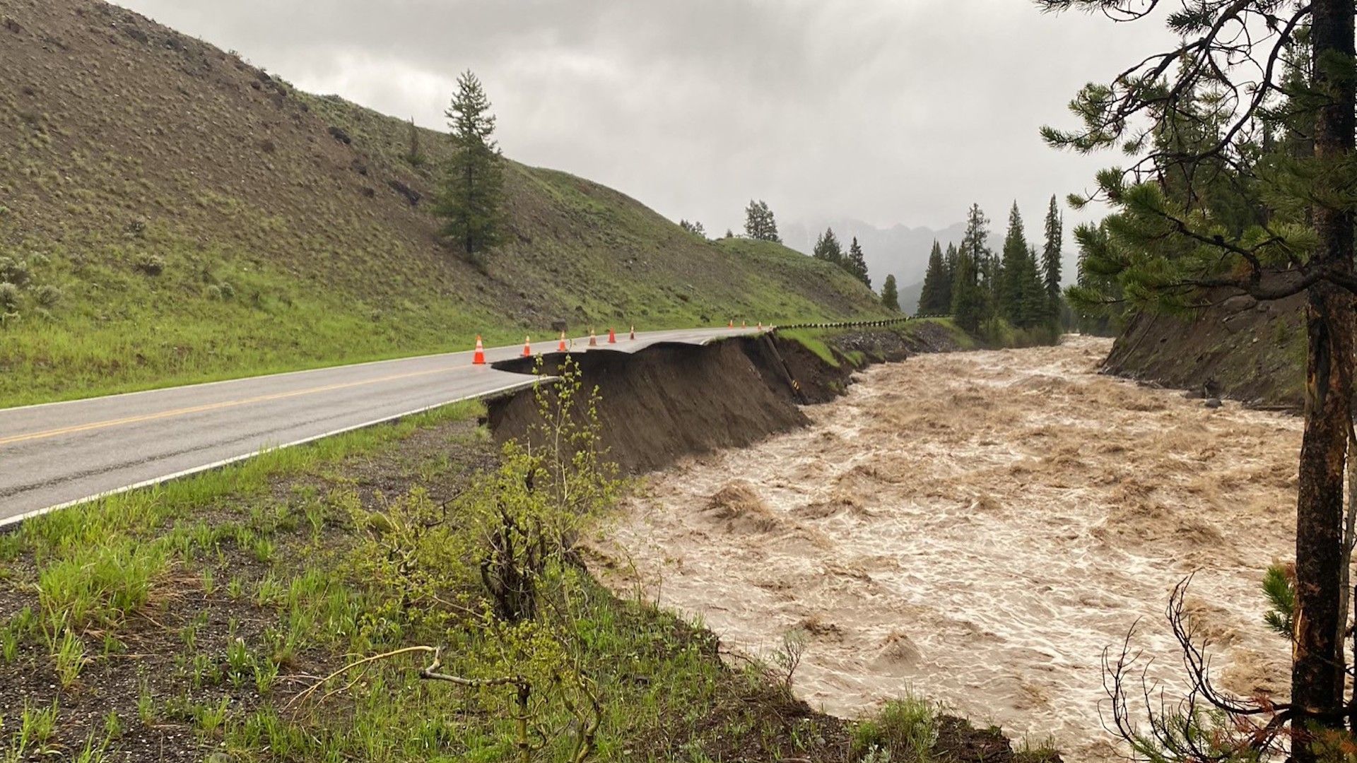 Image of a raging river and collapsing road in Yellowstone National Park.