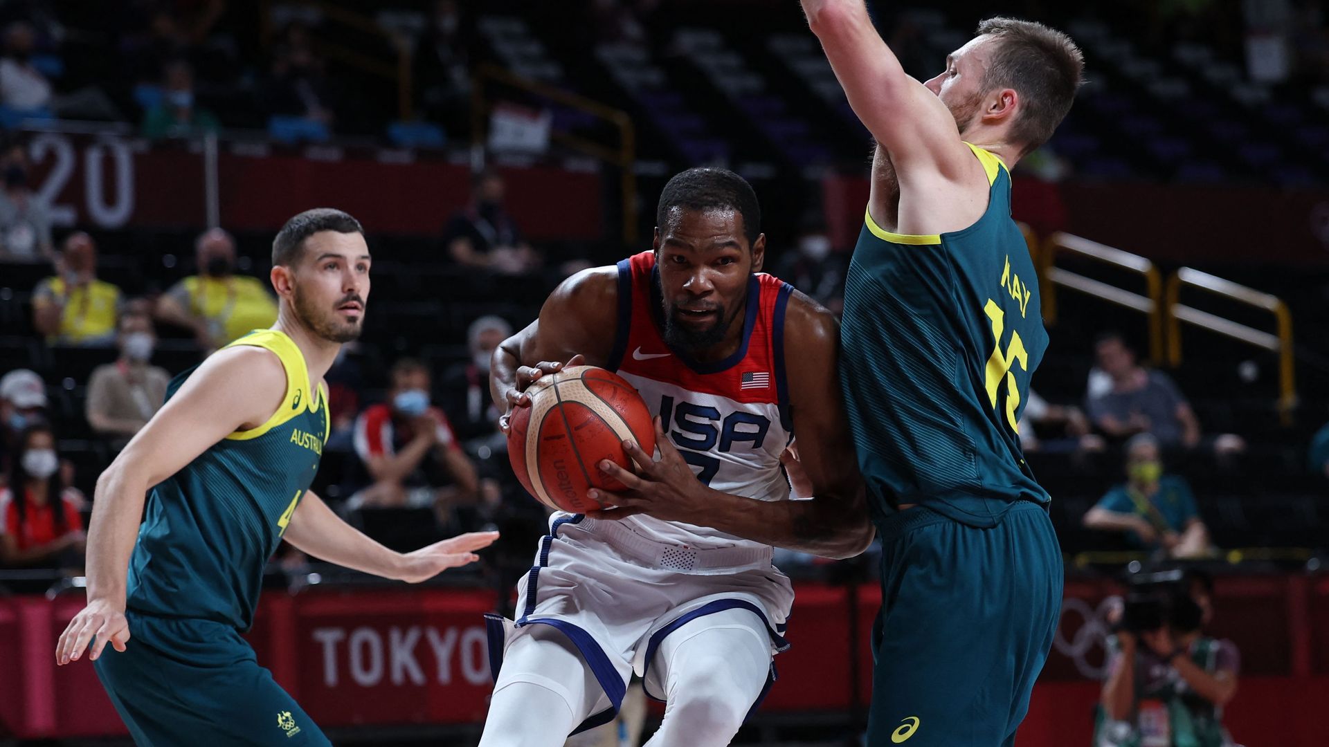 USA's Kevin Wayne Durant (C) runs with the ball past Australia's Chris Goulding (L) and Nic Kay in the men's semi-final basketball match between Australia and USA