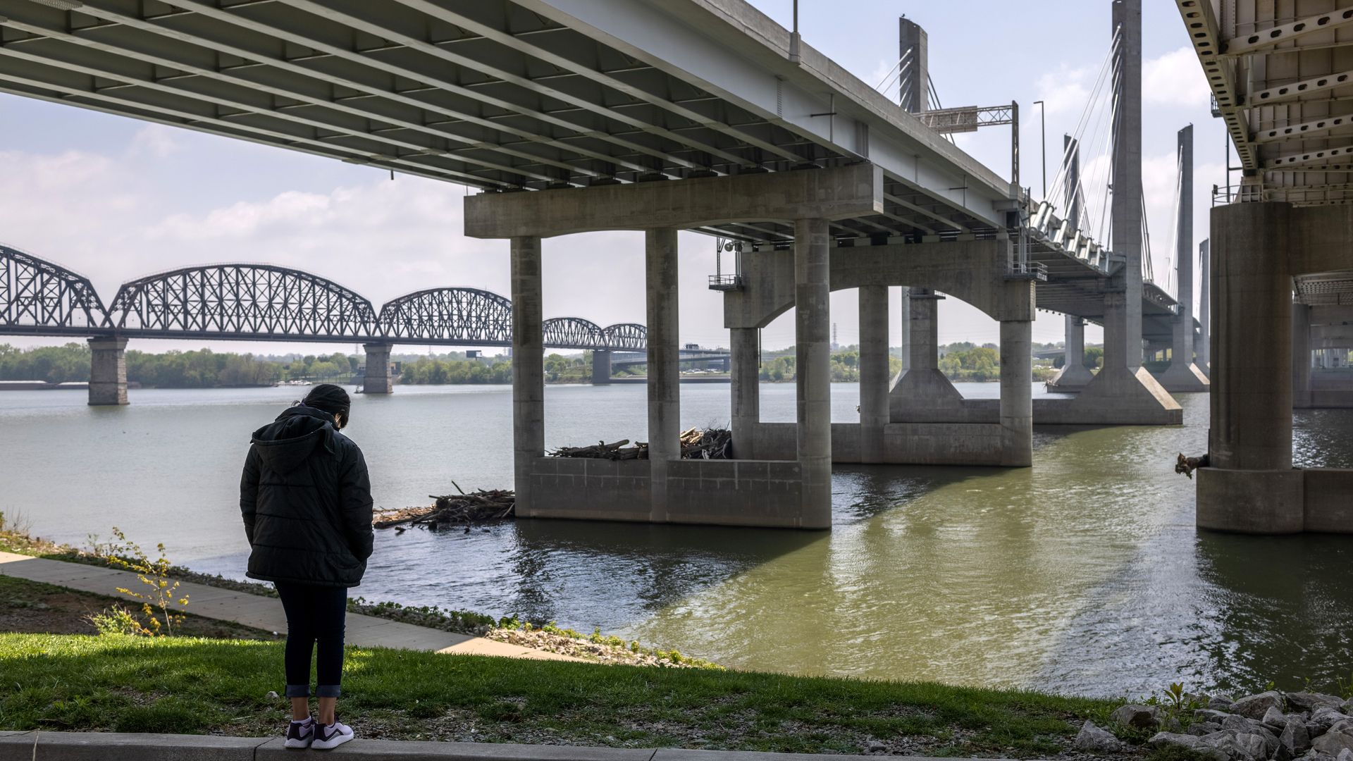 A migrant child sent on to live with relatives after her mother was expelled under Title 42 is seen next to the Ohio River.