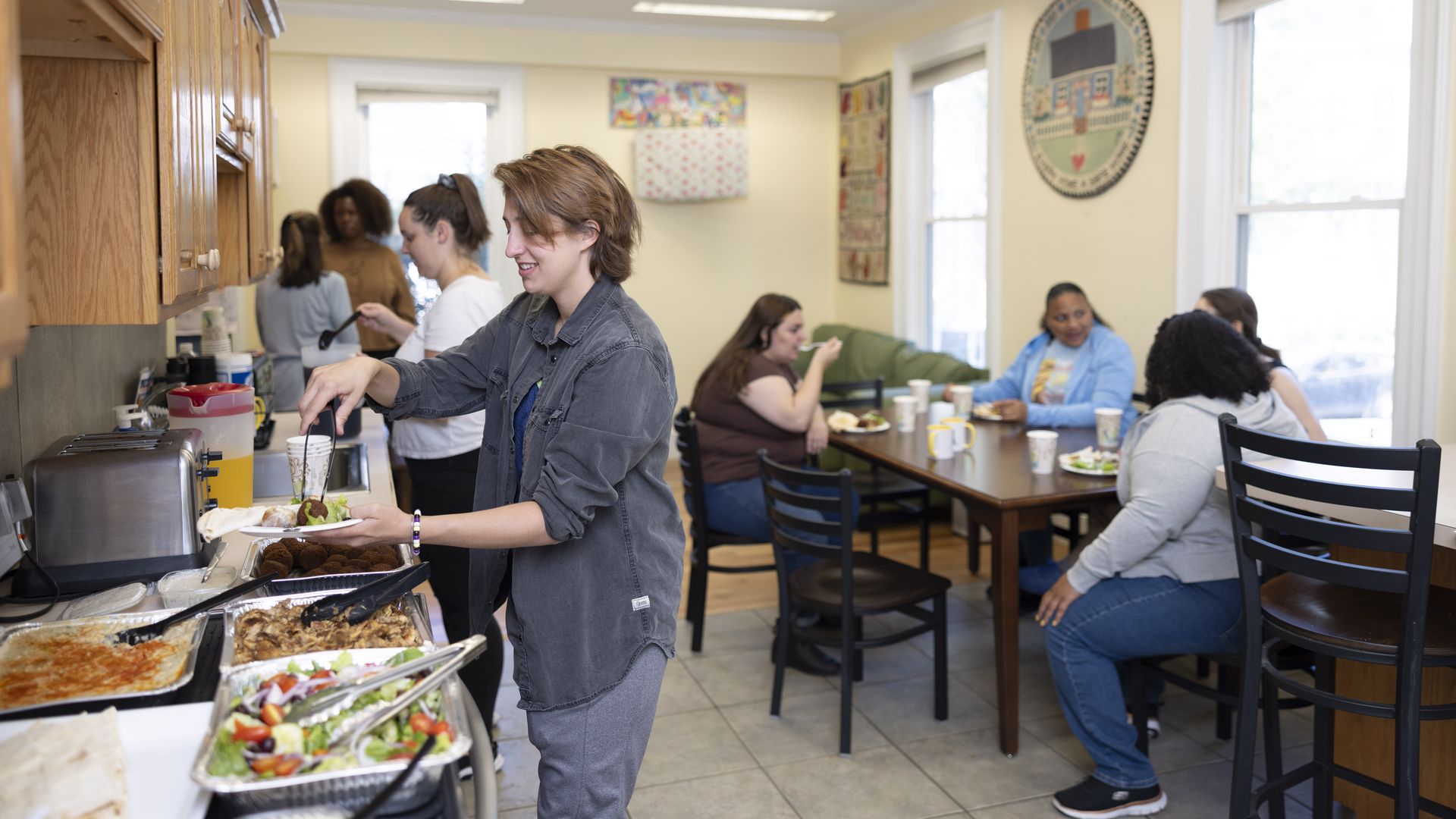 People serve themselves lunch provided by On the Rise, a day shelter for women, transgender and nonbinary people. 