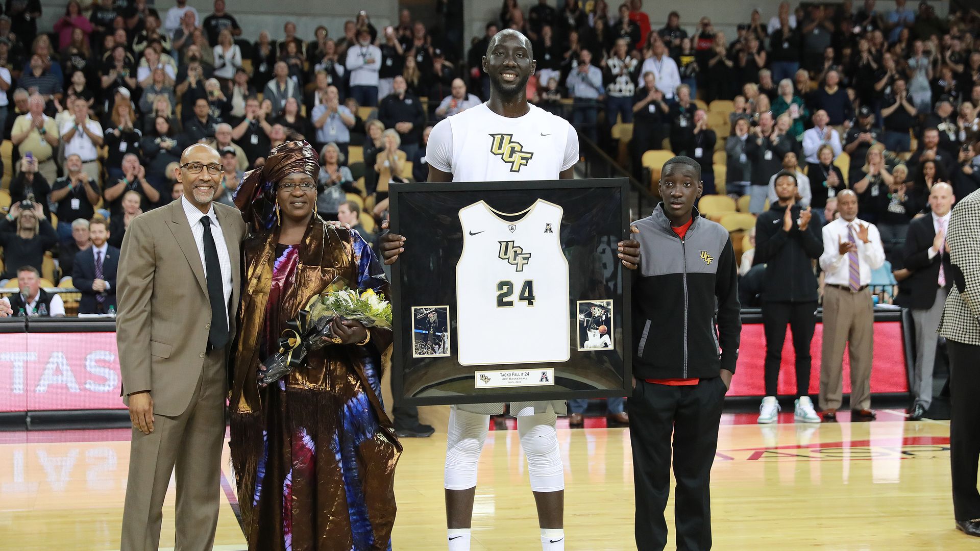Tacko Fall poses with his family on Senior Night