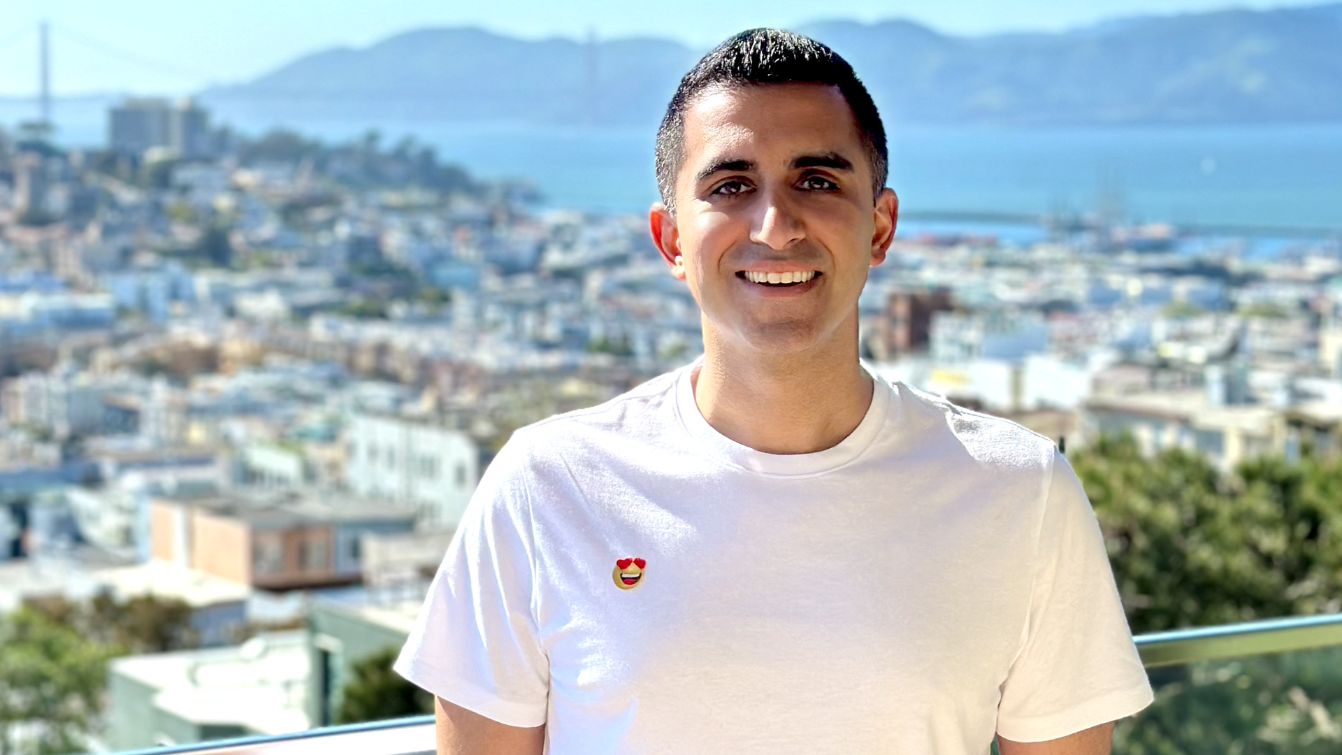 Photo of Rishi Sachdeva in front of San Francisco hills and bay