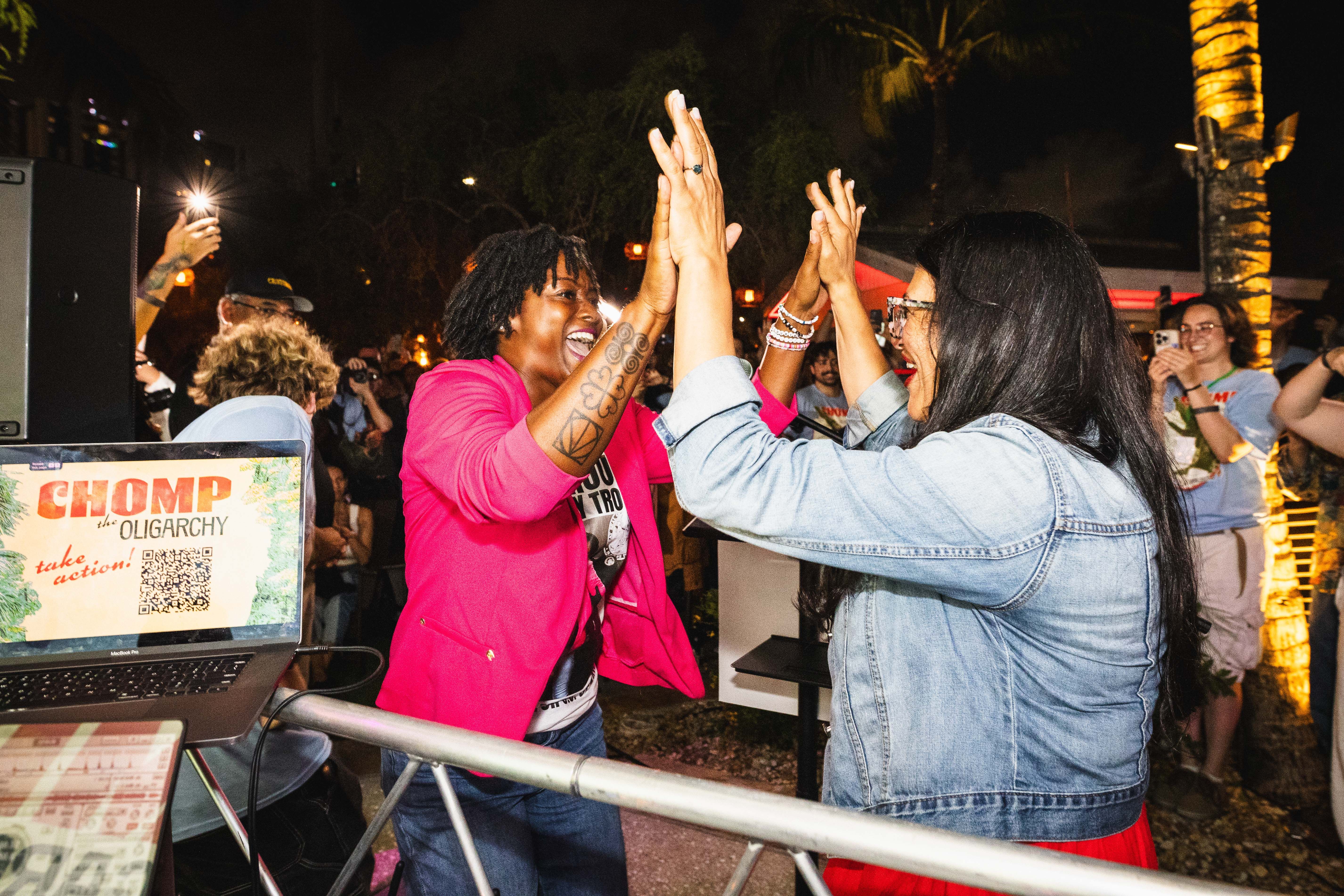 Angie Nixon high-fives Rep. Rashida Tlaib (D-Mich.) at a campaign rally in Fort Lauderdale last week.