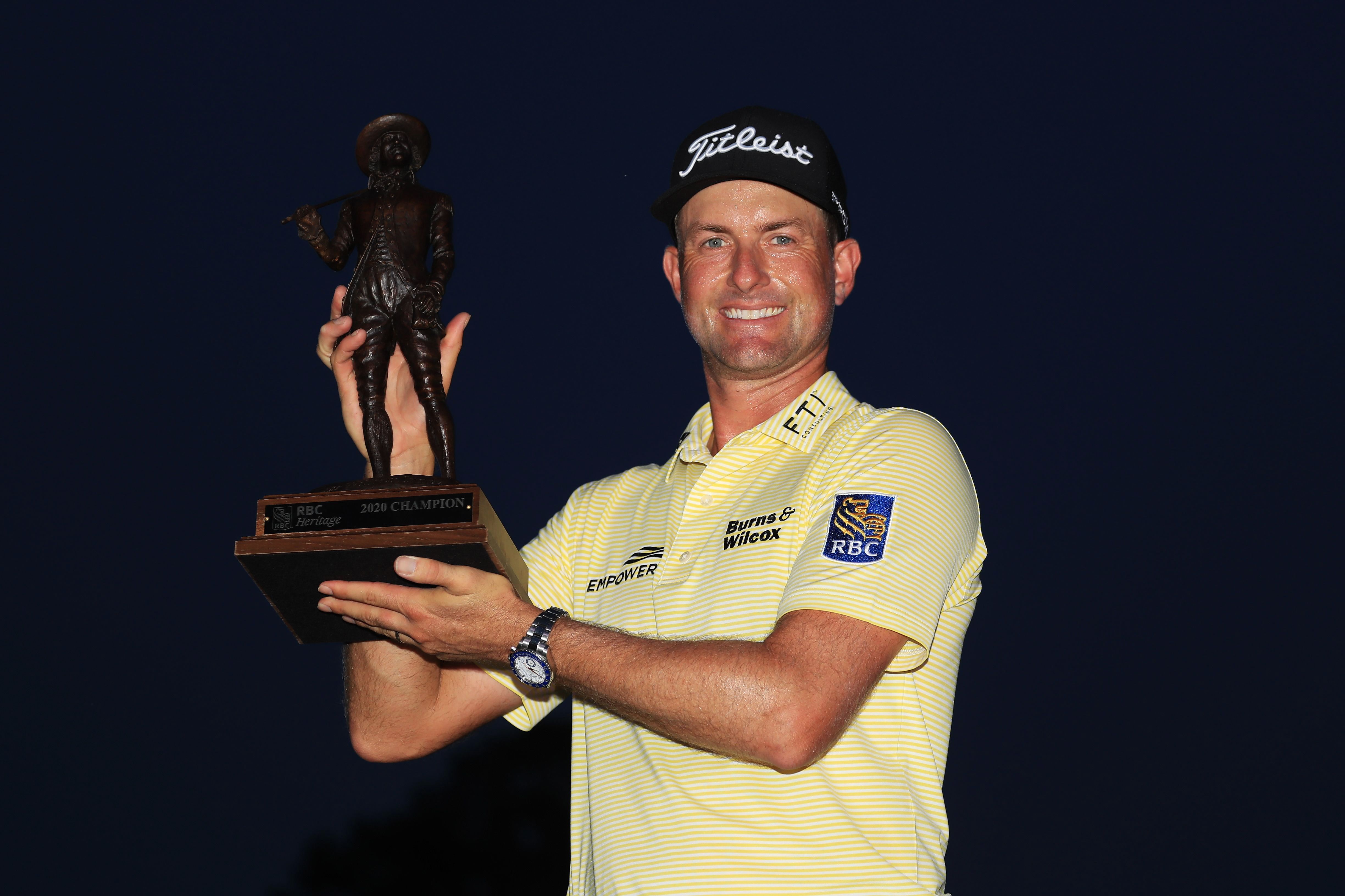 Webb Simpson poses with the trophy