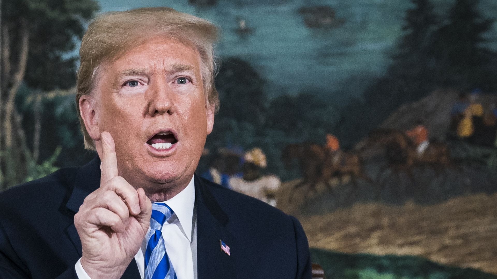 President Trump holds up his finger while speaking