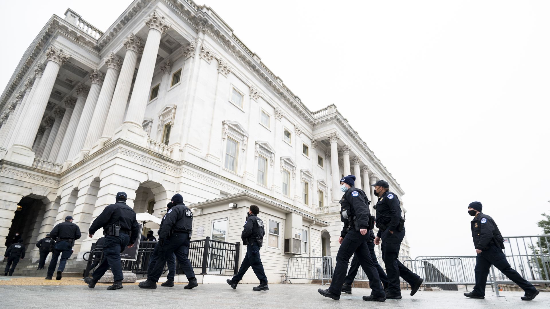 capitol police walking outside the bulding