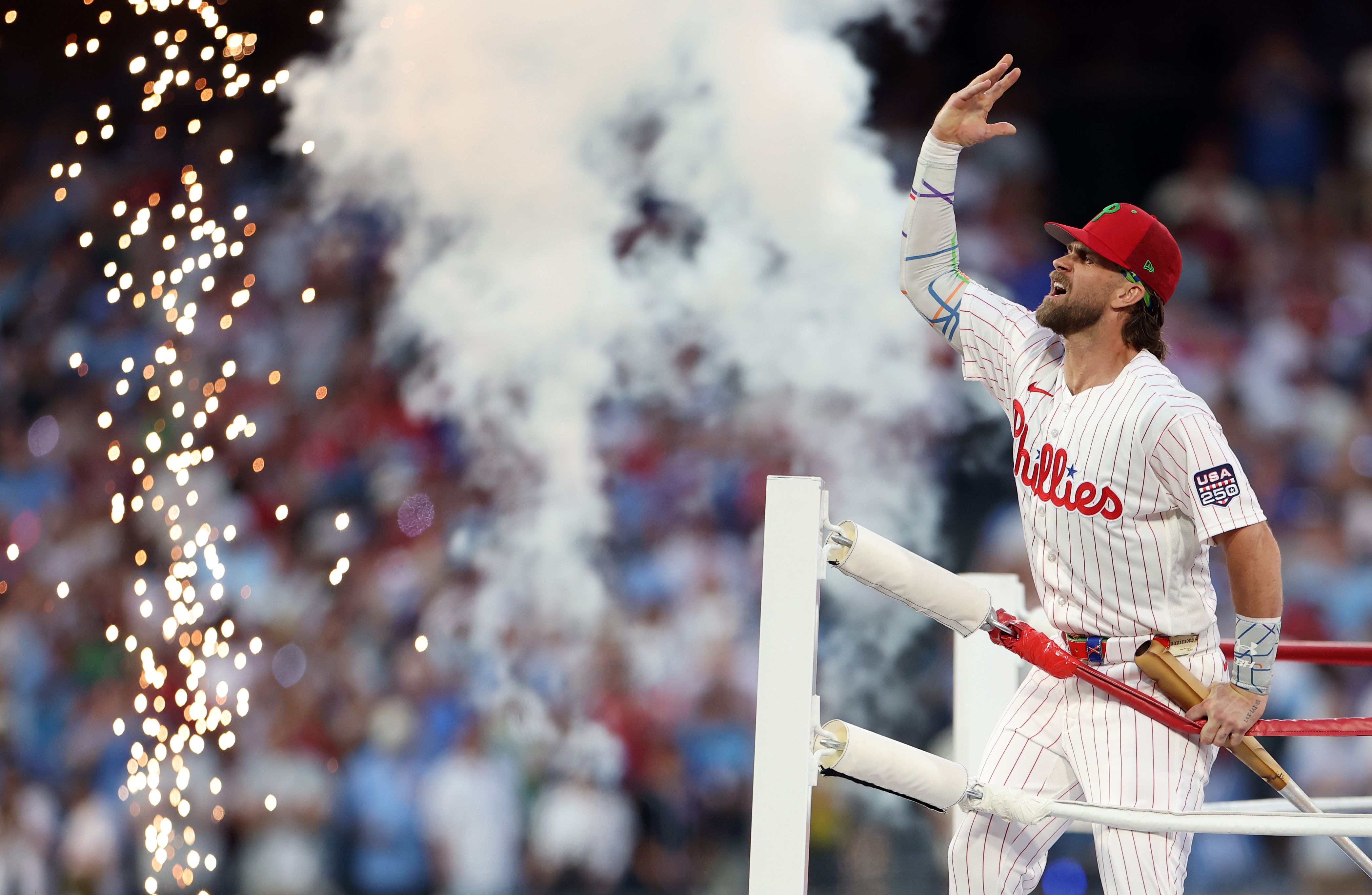 The Phillies' Bryce Harper stands atop the ropes of a makeshift boxing ring. firing up the crowd before the Home Run Derby at Citizens Bank Park.