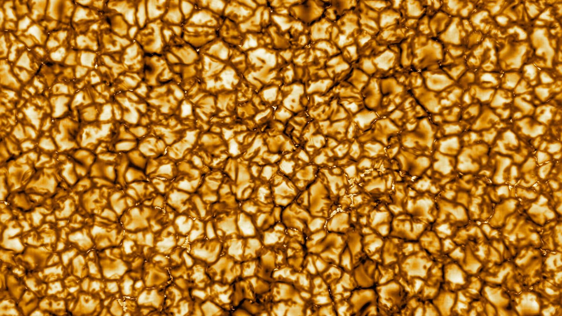 The sun's surface in high-resolution in yellow and orange