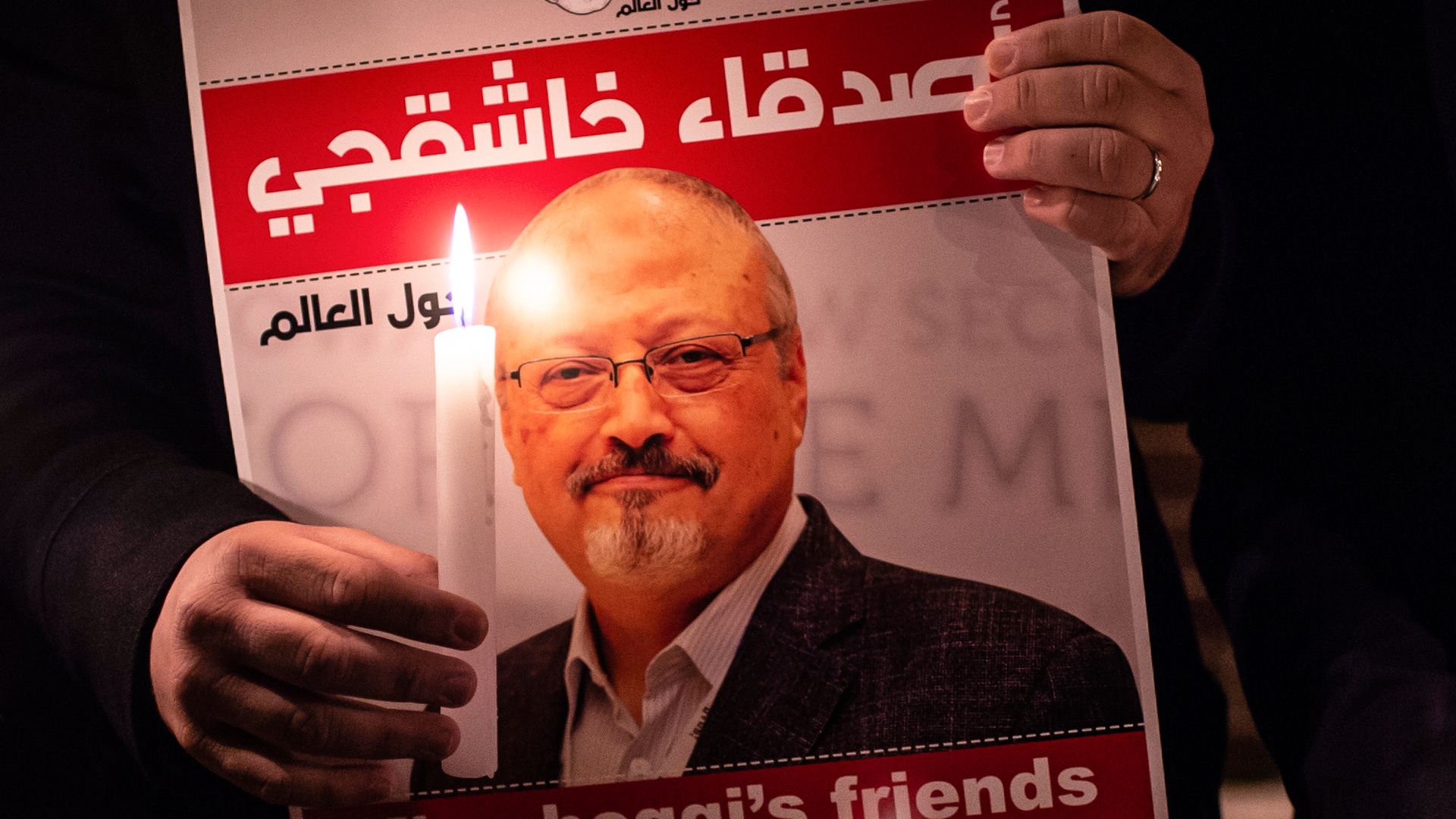 A poster picturing Saudi journalist Jamal Khashoggi and a lightened candle during a gathering outside the Saudi Arabia consulate in Istanbul