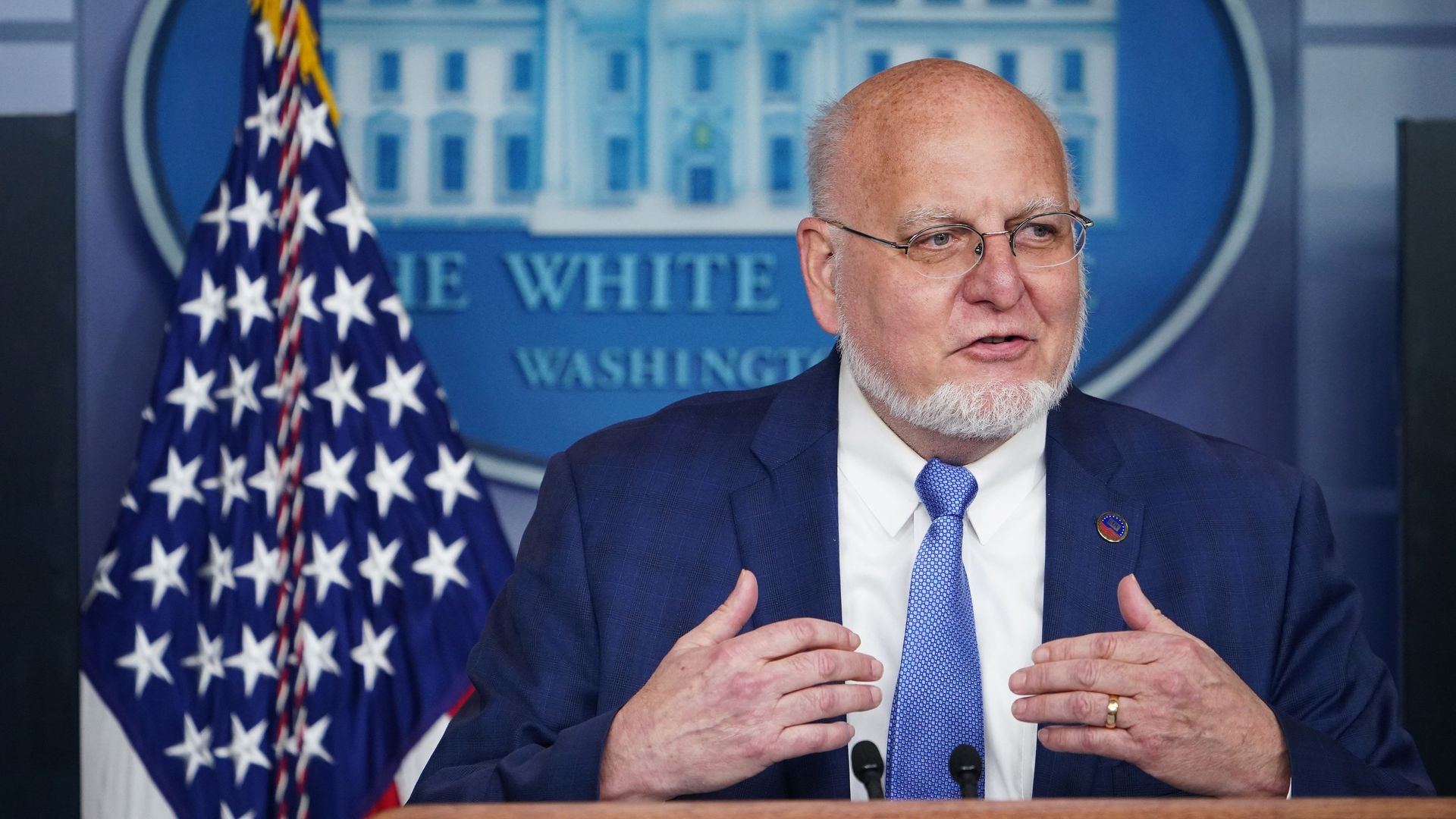 This image shows CDC director Robert Redfield in front of the White House insignia 