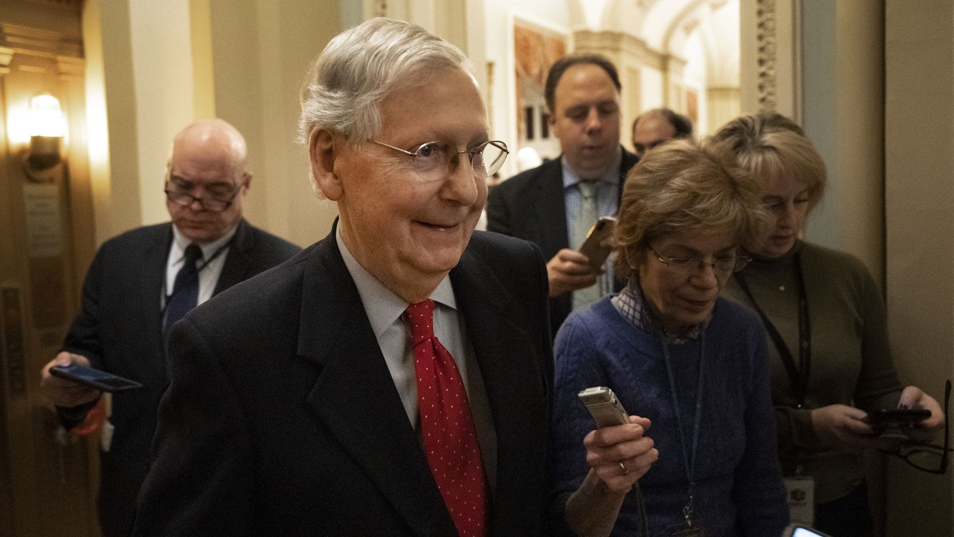 Mitch McConnell walks through the Capitol and talks with reporters