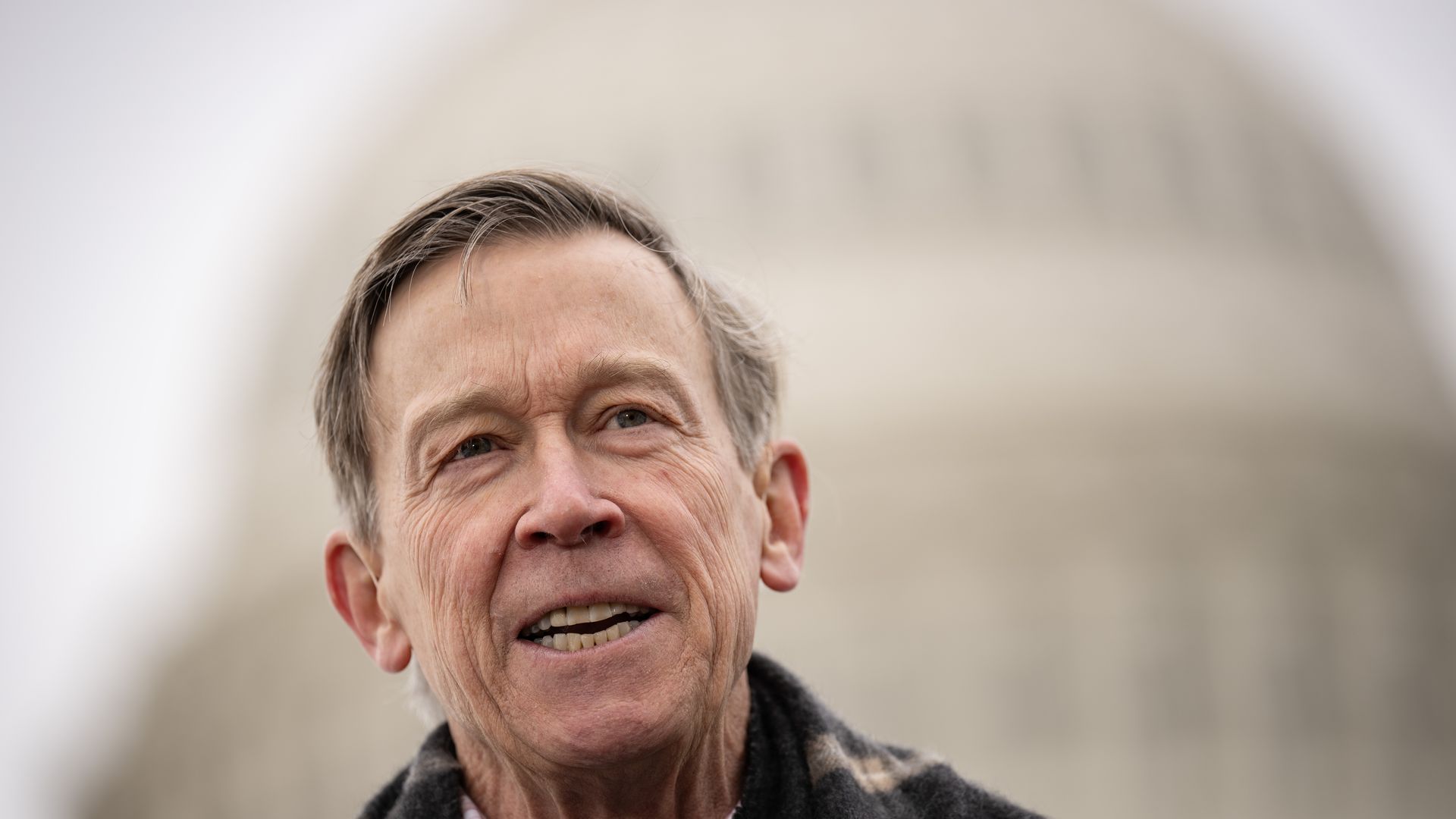 Sen. John Hickenlooper is pictured speaking outside of the Capitol