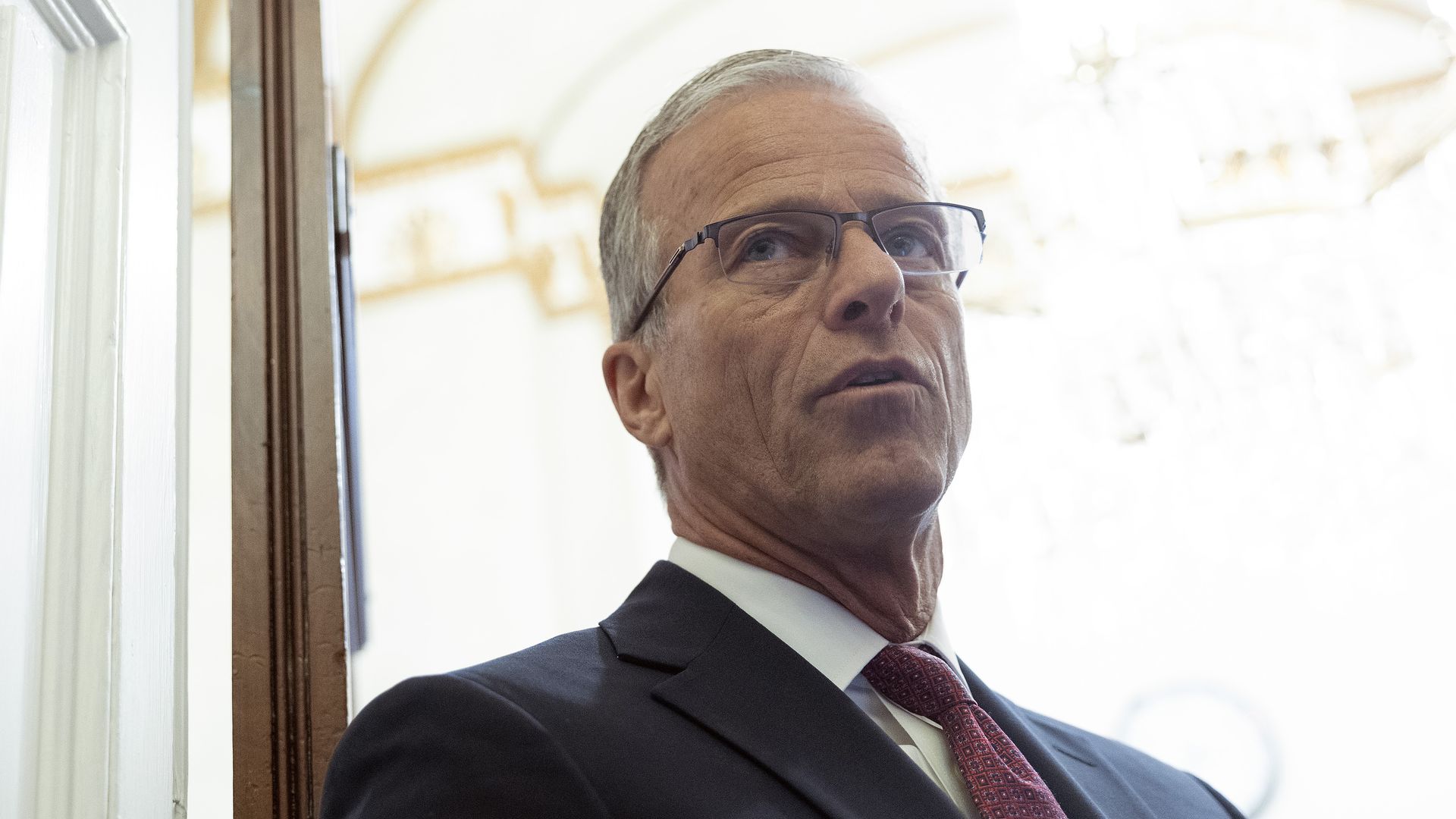 Senate Majority Leader John Thune (R-SD) talks to reporters as he walks into his office at the U.S. Capitol on Aug. 3.