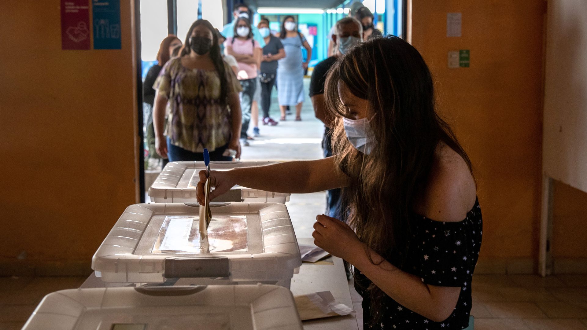 A voter casts her ballot during national elections on November 21, 2021 in Arica, Chile. 