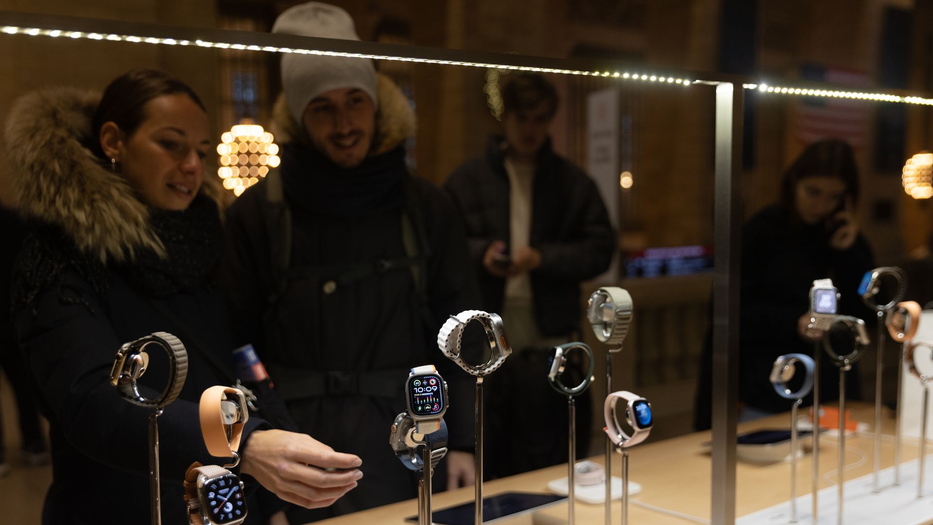 Shoppers looking at Apple Watches in a store