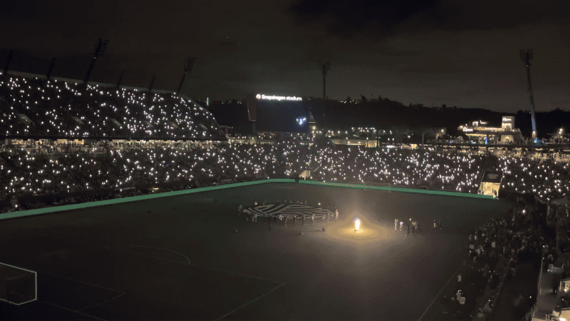 A firework show on a soccer field.