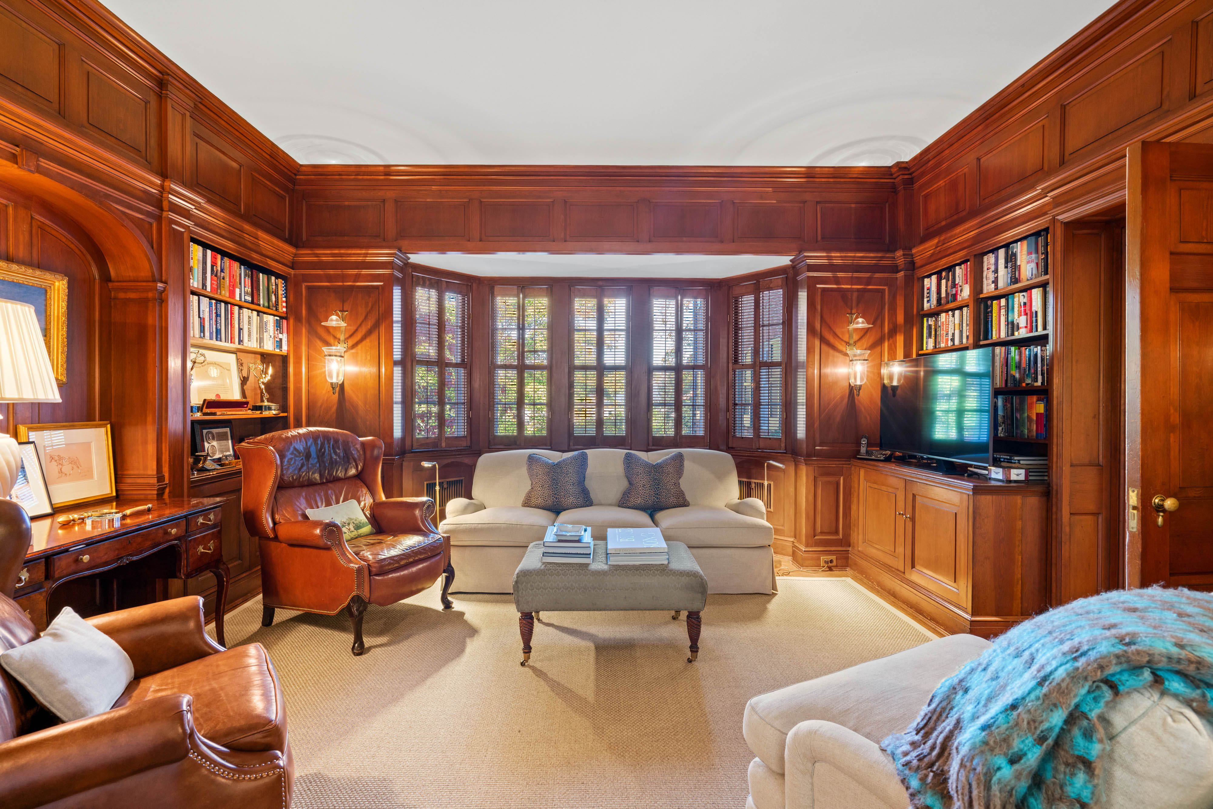 A photo of a wood-paneled study.