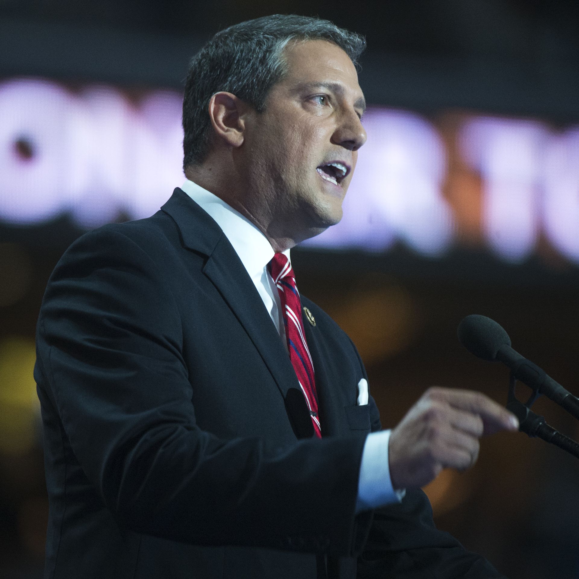 In this image, Tim Ryan speaks into a microphone on stage. 