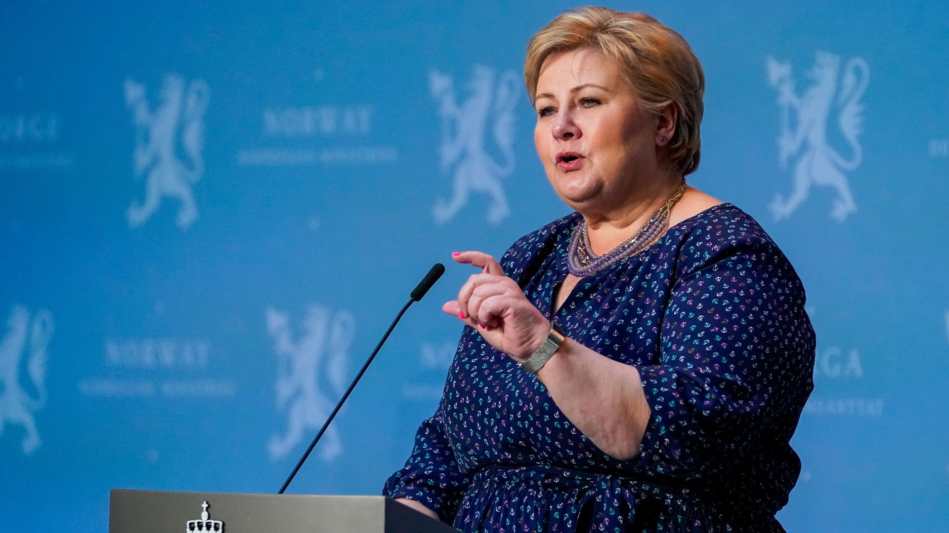 Norwegian Prime Minister Erna Solberg speaks at a podium.