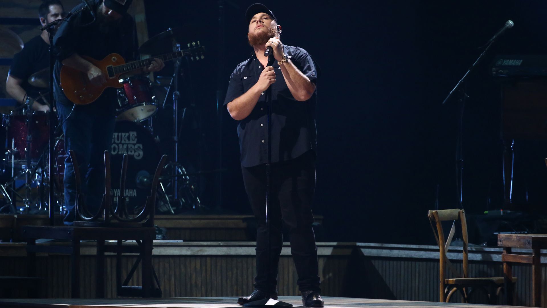 Luke Combs performs at the CMA Awards on Wednesday in a black button down short sleeve shirt