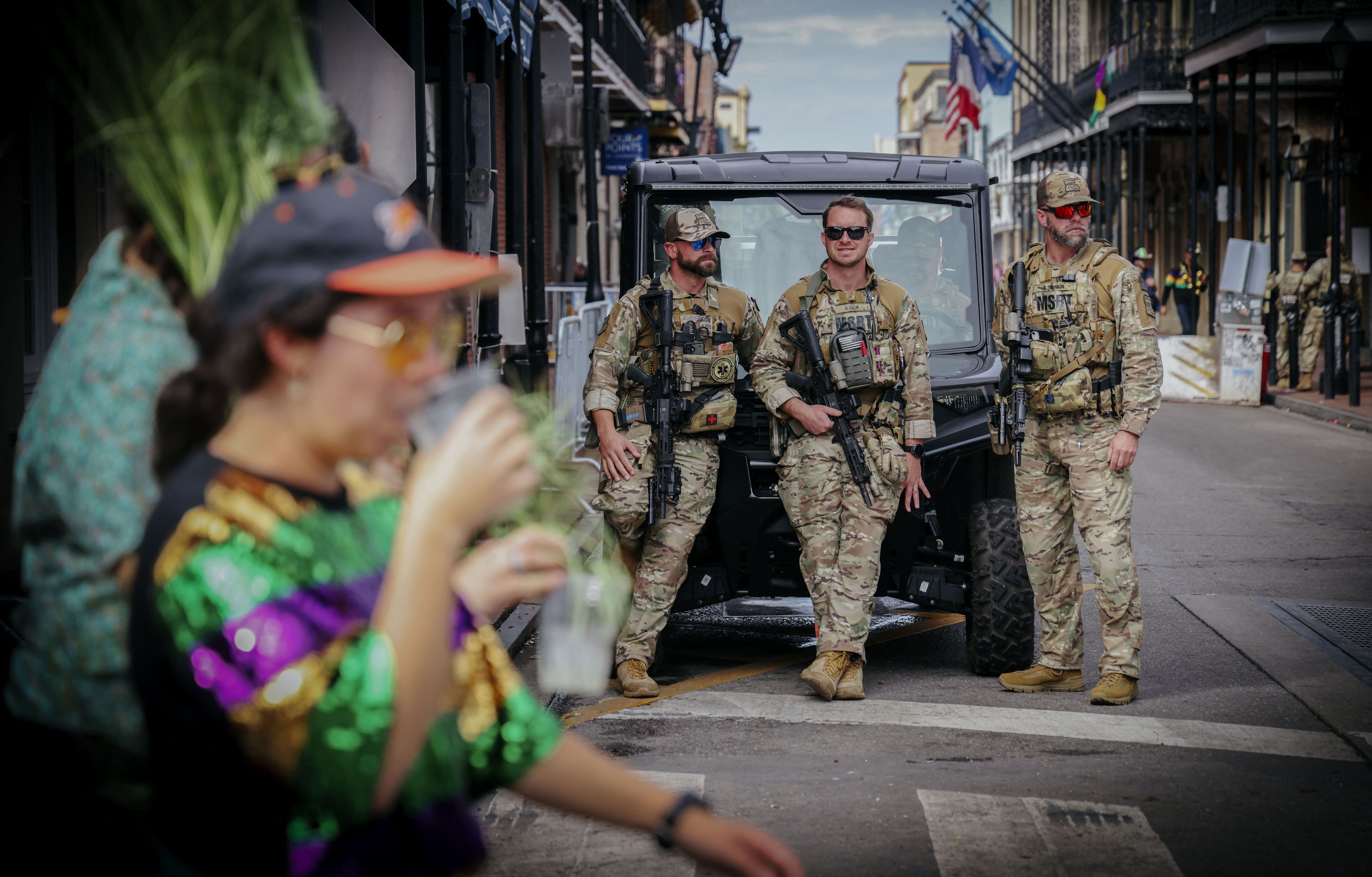 National Guardsmen look on while on patrol along Bourbon Street in New Orleans during Mardi Gras Day festivities.