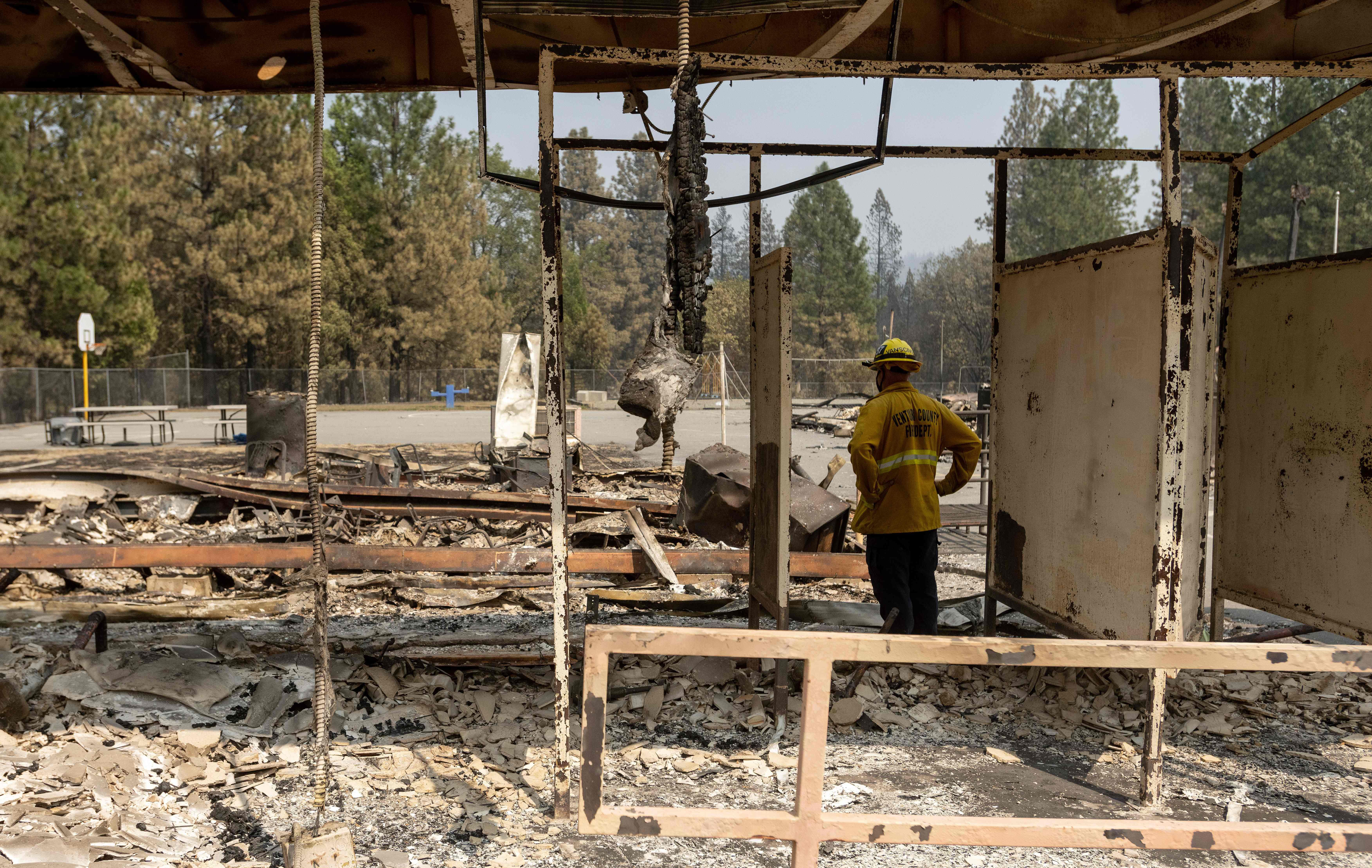 A firefighter surveys the burned remains of Berry Creek School in California on September 14, 2020.