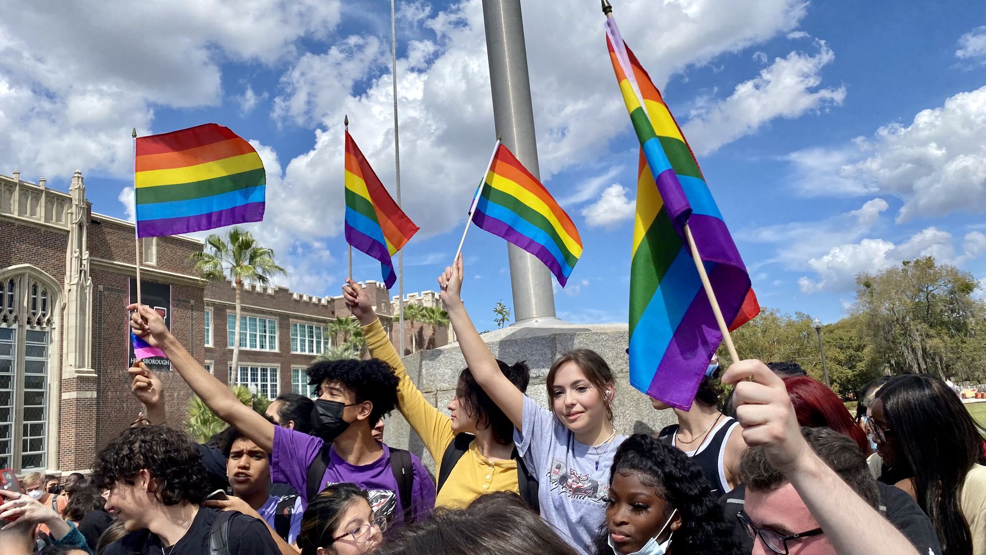 Student protesters hold rainbow flags