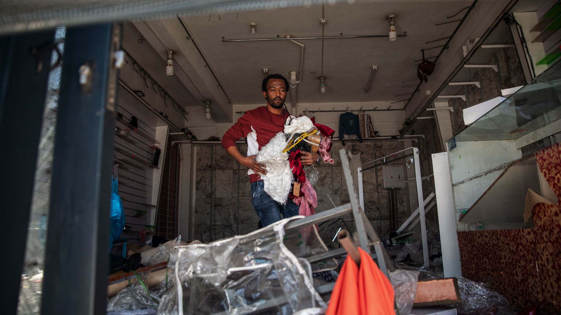 A foreign shop owner checks the damages to his looted shop in Johannesburg, South Africa, on Tueaday.