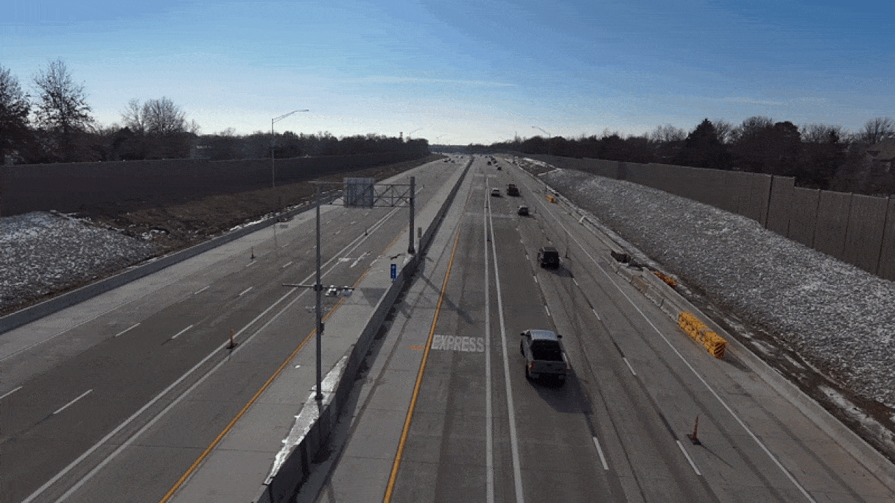 A multi-lane highway, U.S. 69 in Johnson County, with light traffic, bordered by bare trees and snow patches under a clear blue sky, featuring lanes marked as "Express."