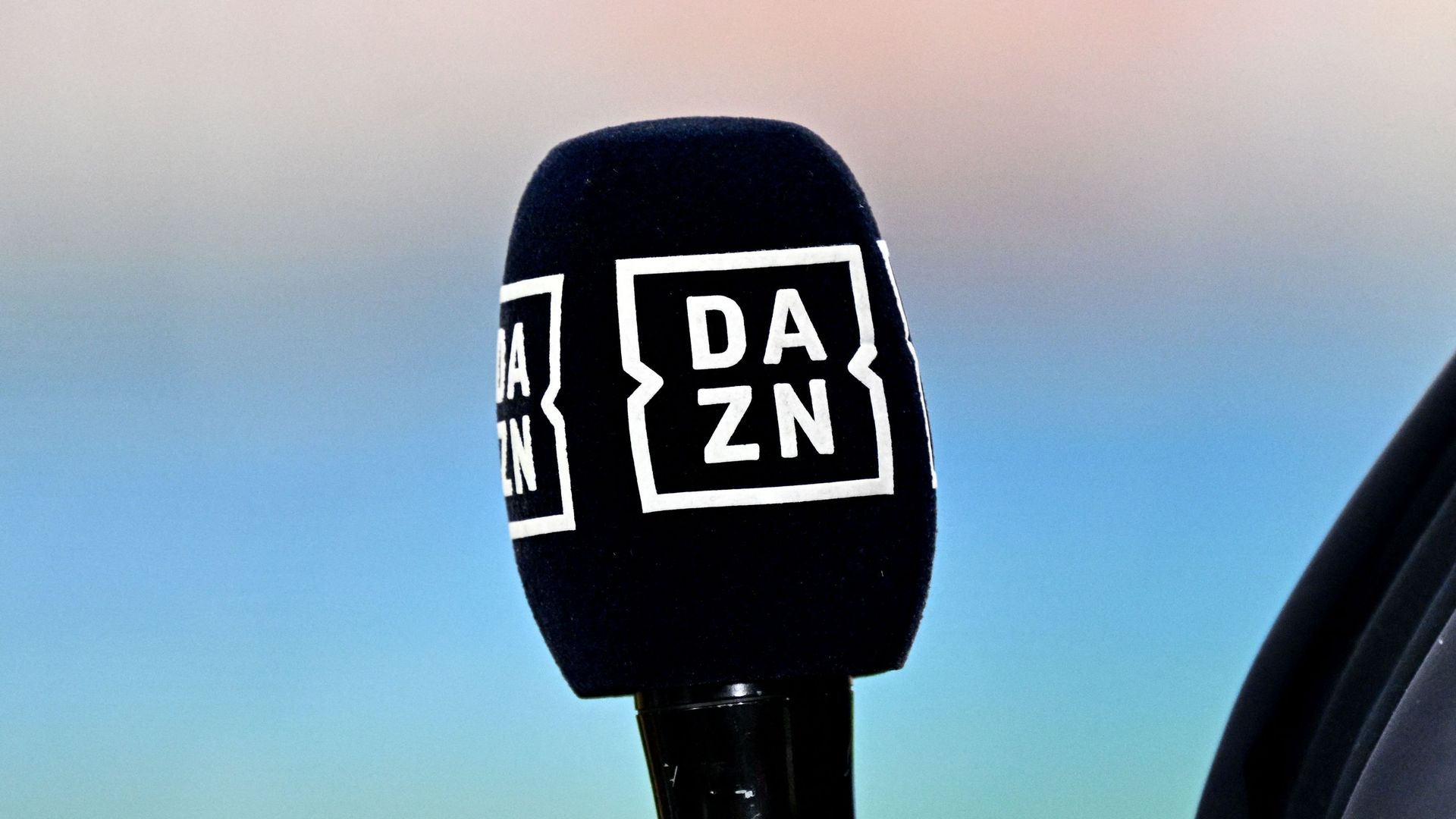 he logo of online media DAZN is seen on a microphone prior the Italian Serie A football match between AC Milan and Lazio at the San Siro Stadium in Milan on September 30, 2023.
