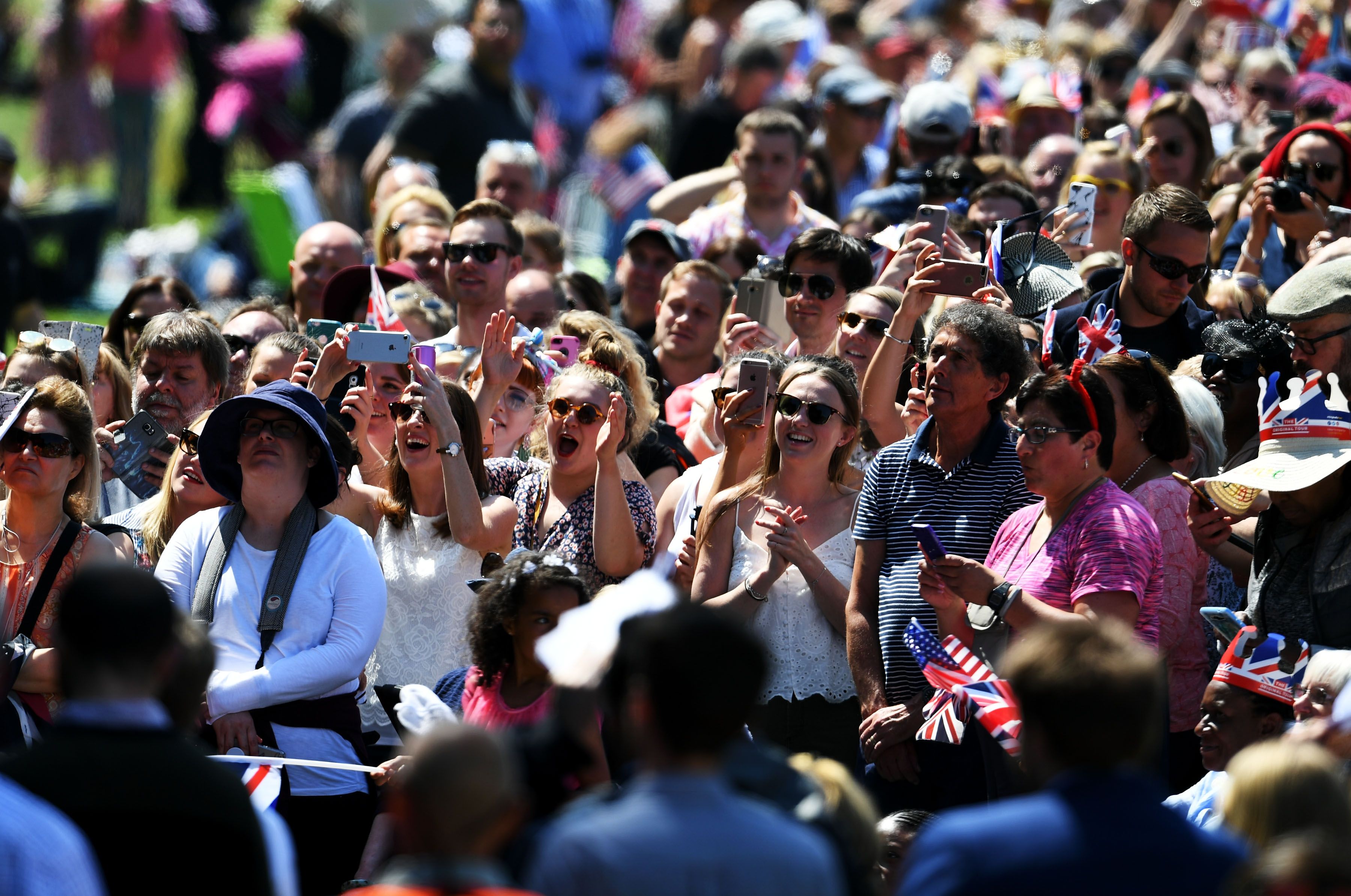 The crowd reacts as Ms. Meghan Markle's car makes it's way down The Long Walk