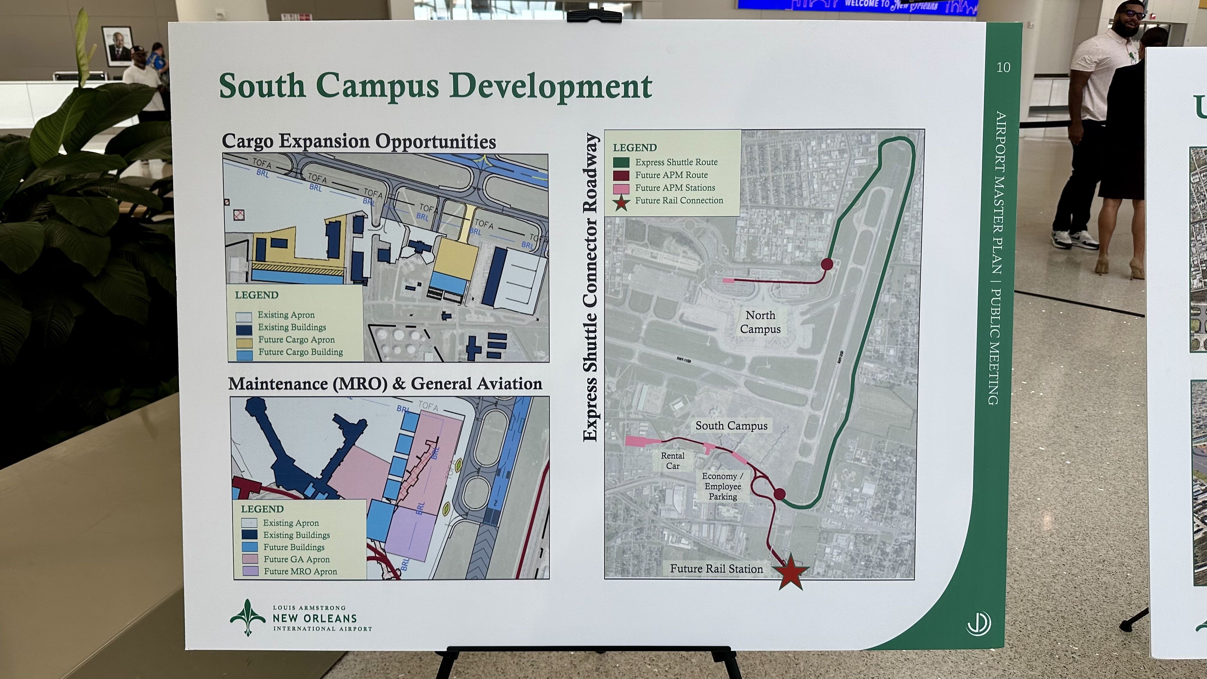 Poster board titled South Campus Development showing cargo expansion and MRO maps, plus an Express Shuttle Connector Road map; includes legends, the Louis Armstrong New Orleans Airport logo, and people in the background.