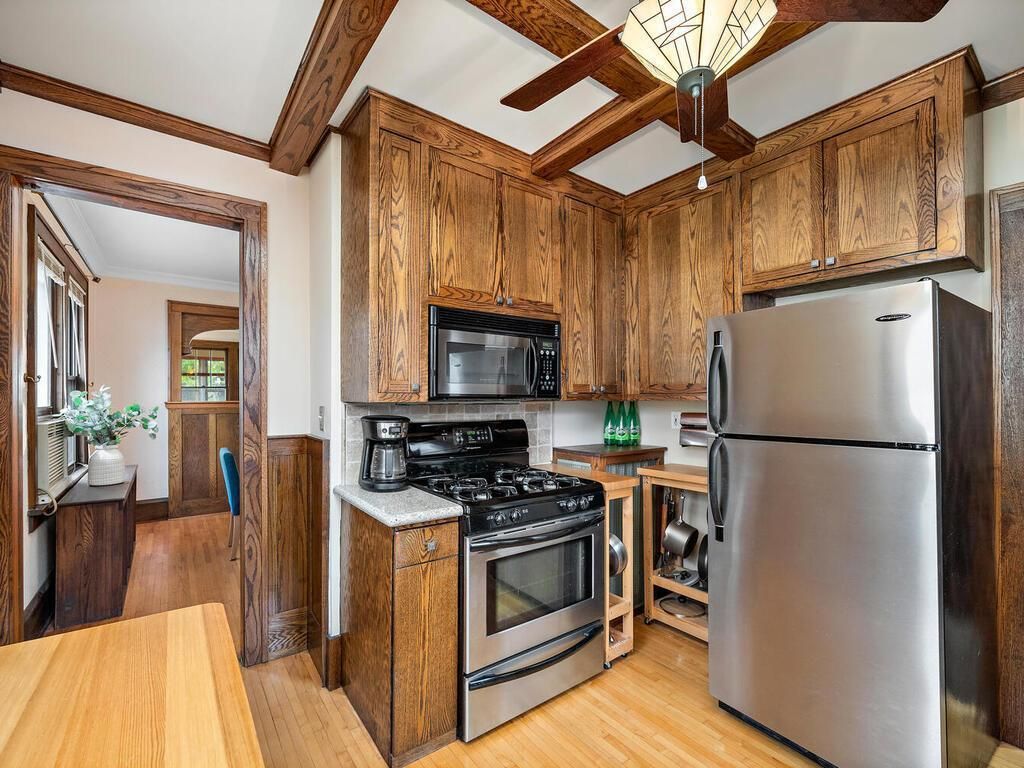 traditional kitchen with newer appliances and lots of woodwork