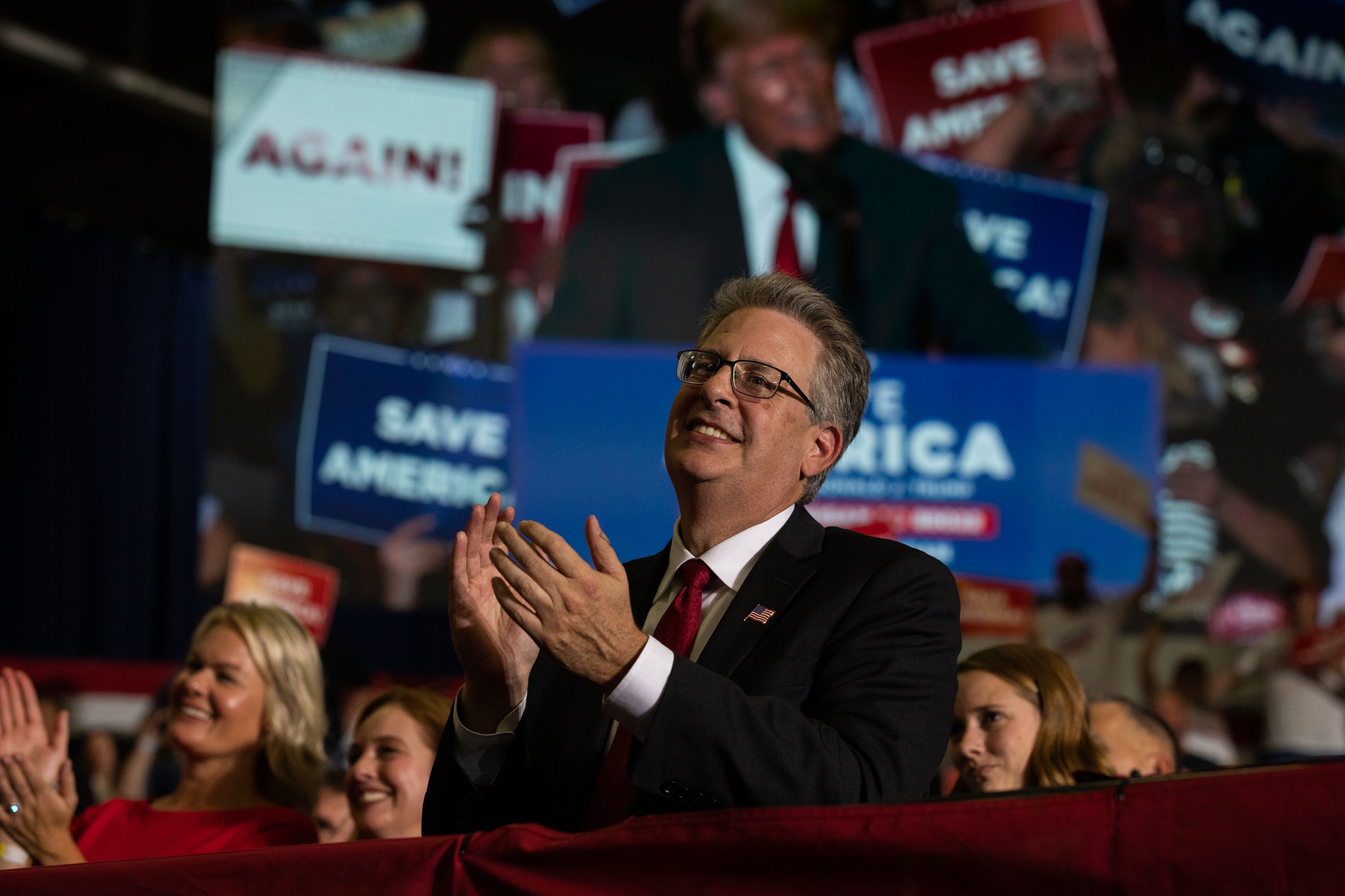 Then-Republican candidate for Attorney General Matthew DePerno claps during former President Donald Trump's remarks during a Save America rally on October 1, 2022 in Warren, Michigan. 