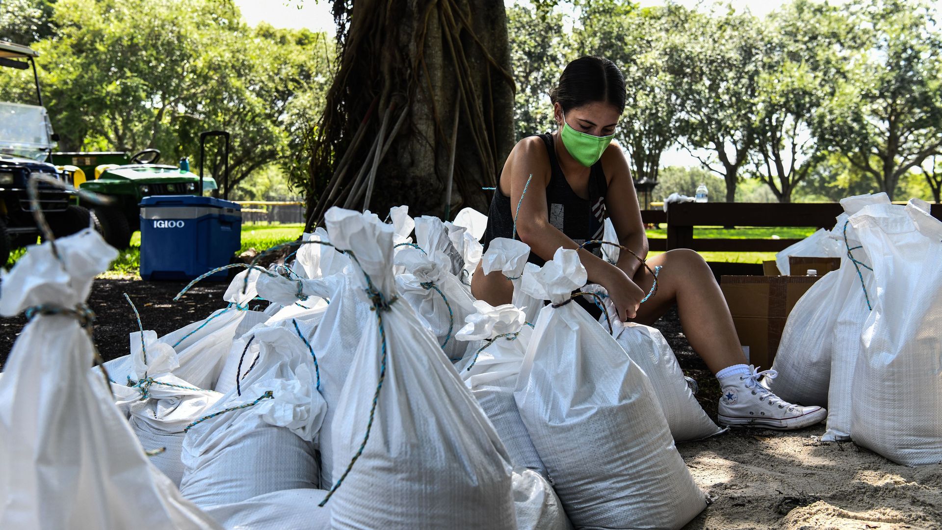 A woman prepares sand bags for distribution to the residents of Palmetto Bay near Miami on July 31, 2020 as Floridians prepared for a hurricane. Photo: Chandan Khanna/AFP via Getty Images