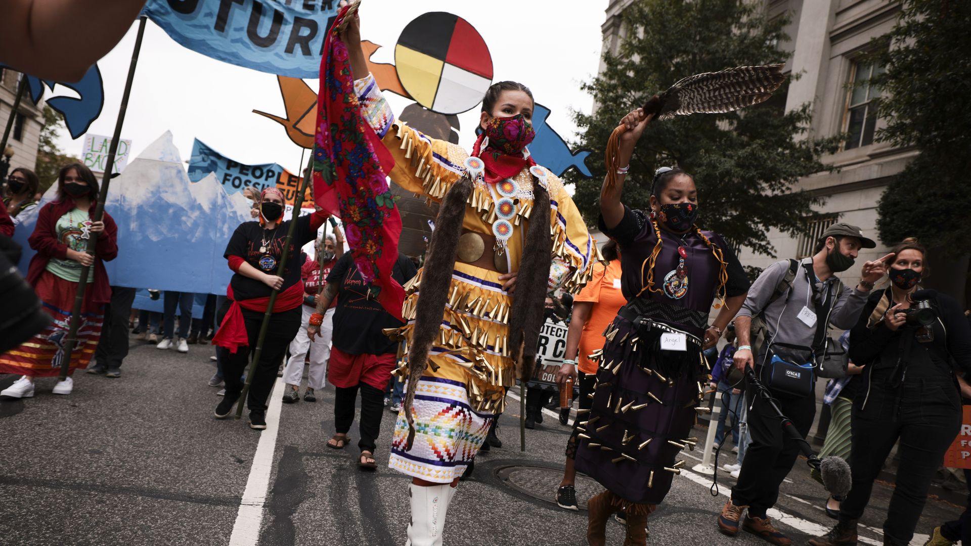 Demonstrators dance as they march in honor of Indigenous Peoples’ Day at Freedom Plaza on October 11