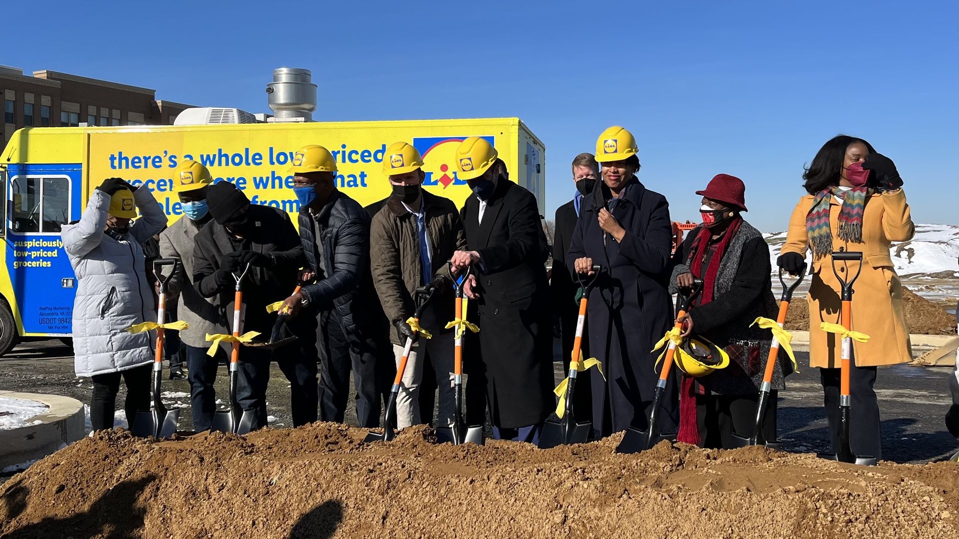 A group breaks ground on a new Lidl. 